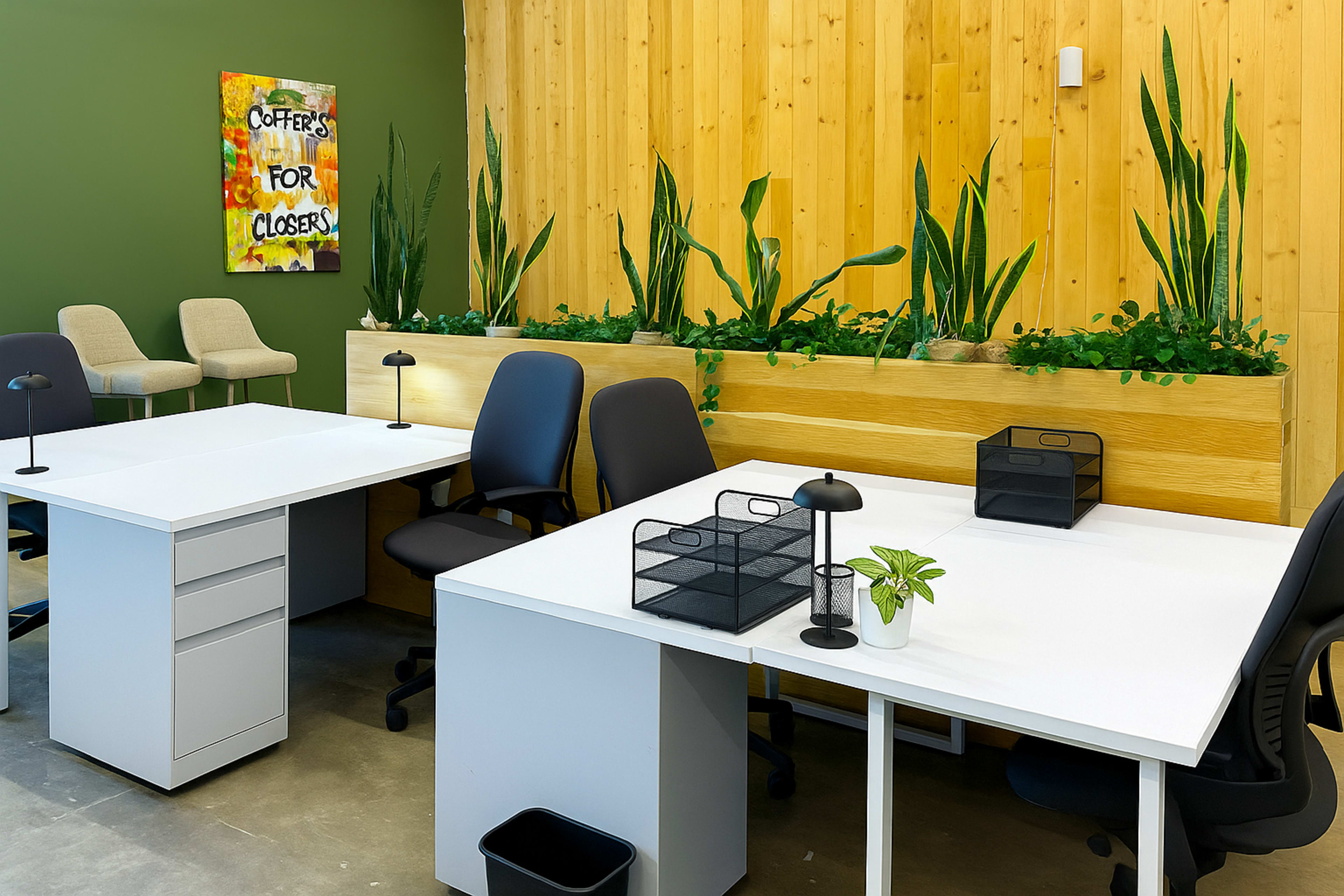 The image shows a modern office space with two white desks, black chairs, and decorative plants against a wooden wall.