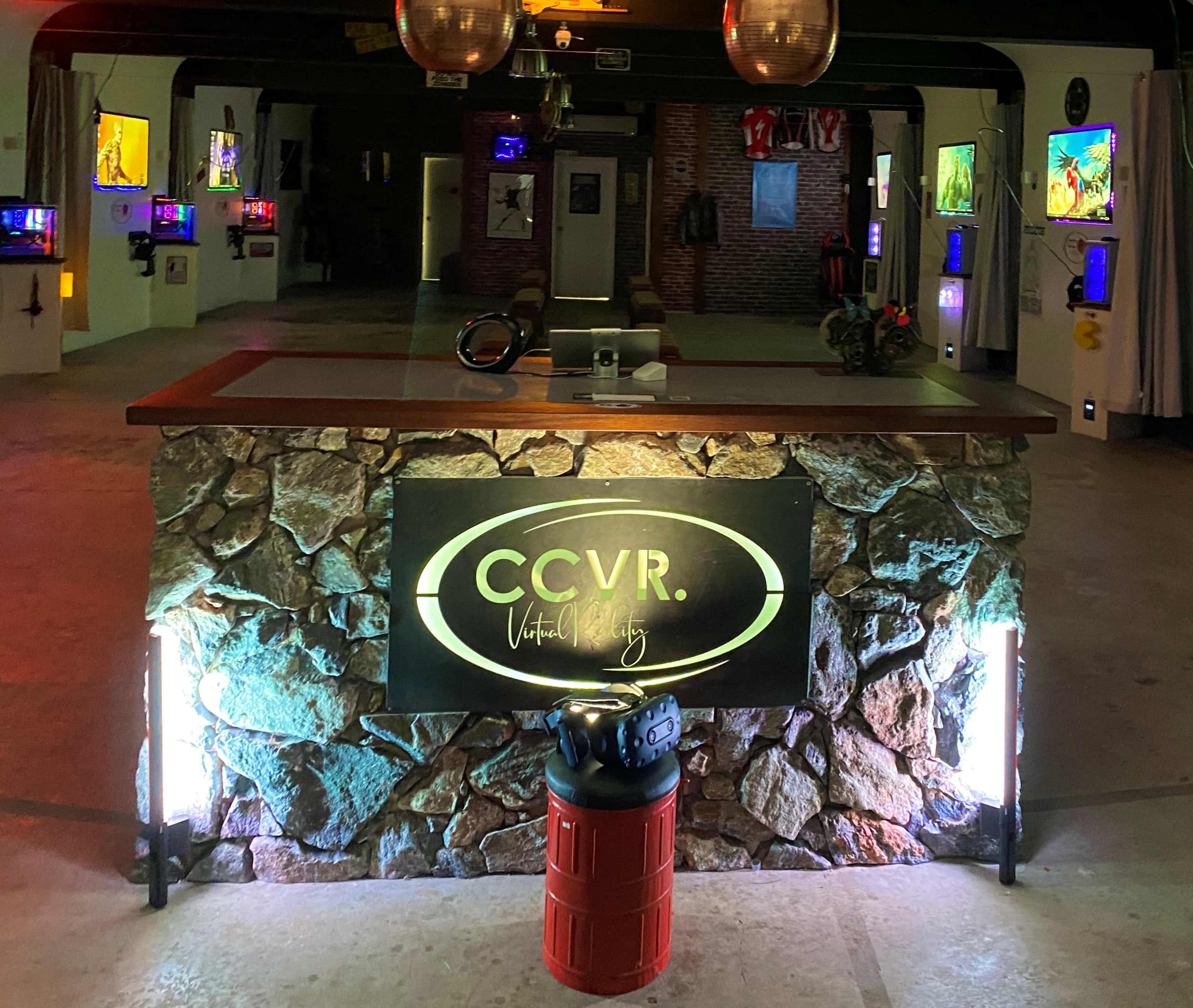 A stone counter with a sign reading "CCVR" in a brightly lit room adorned with colorful artwork and displays.