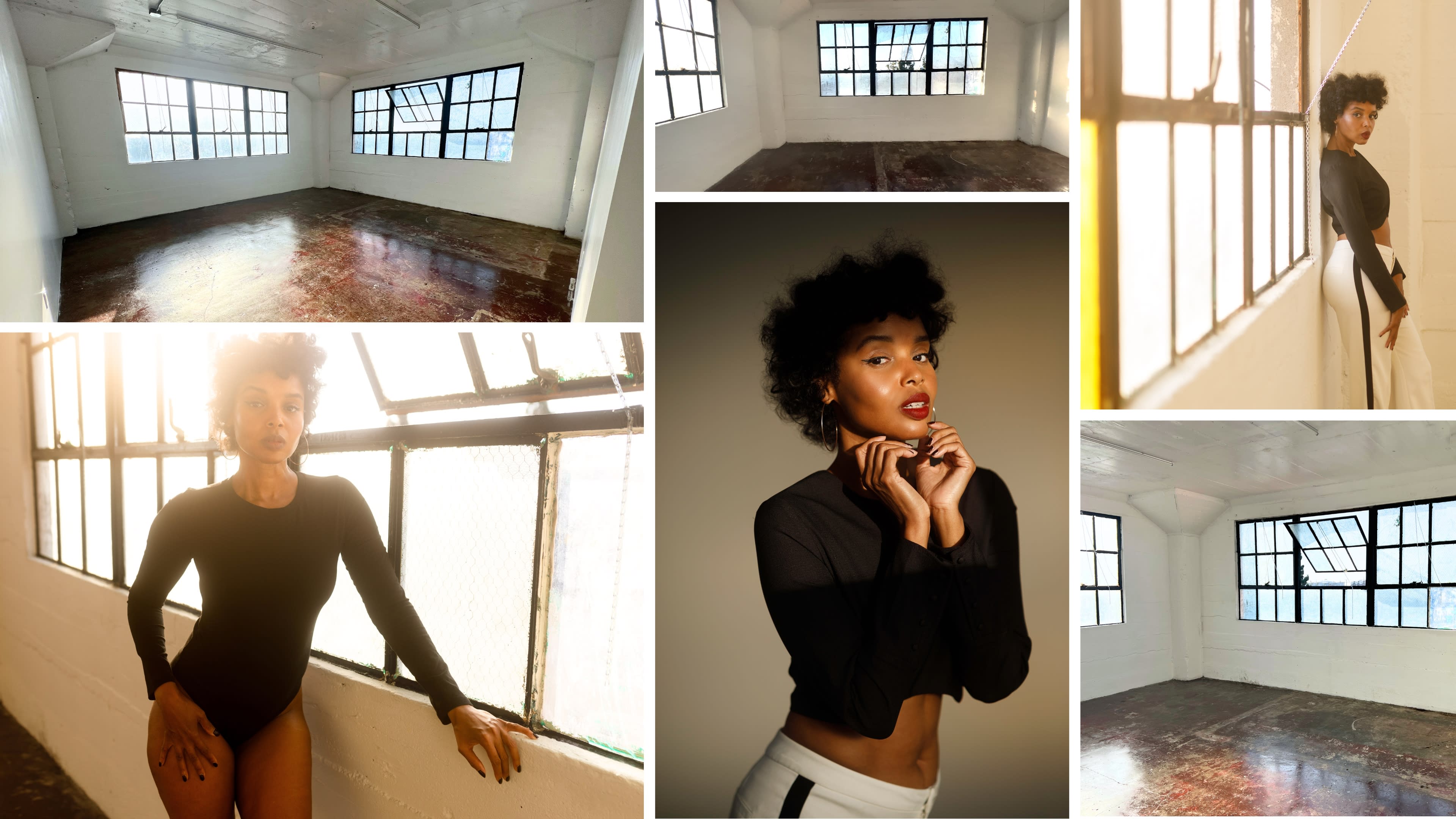 A model with curly hair posing in a brightly lit, empty studio room with large windows.