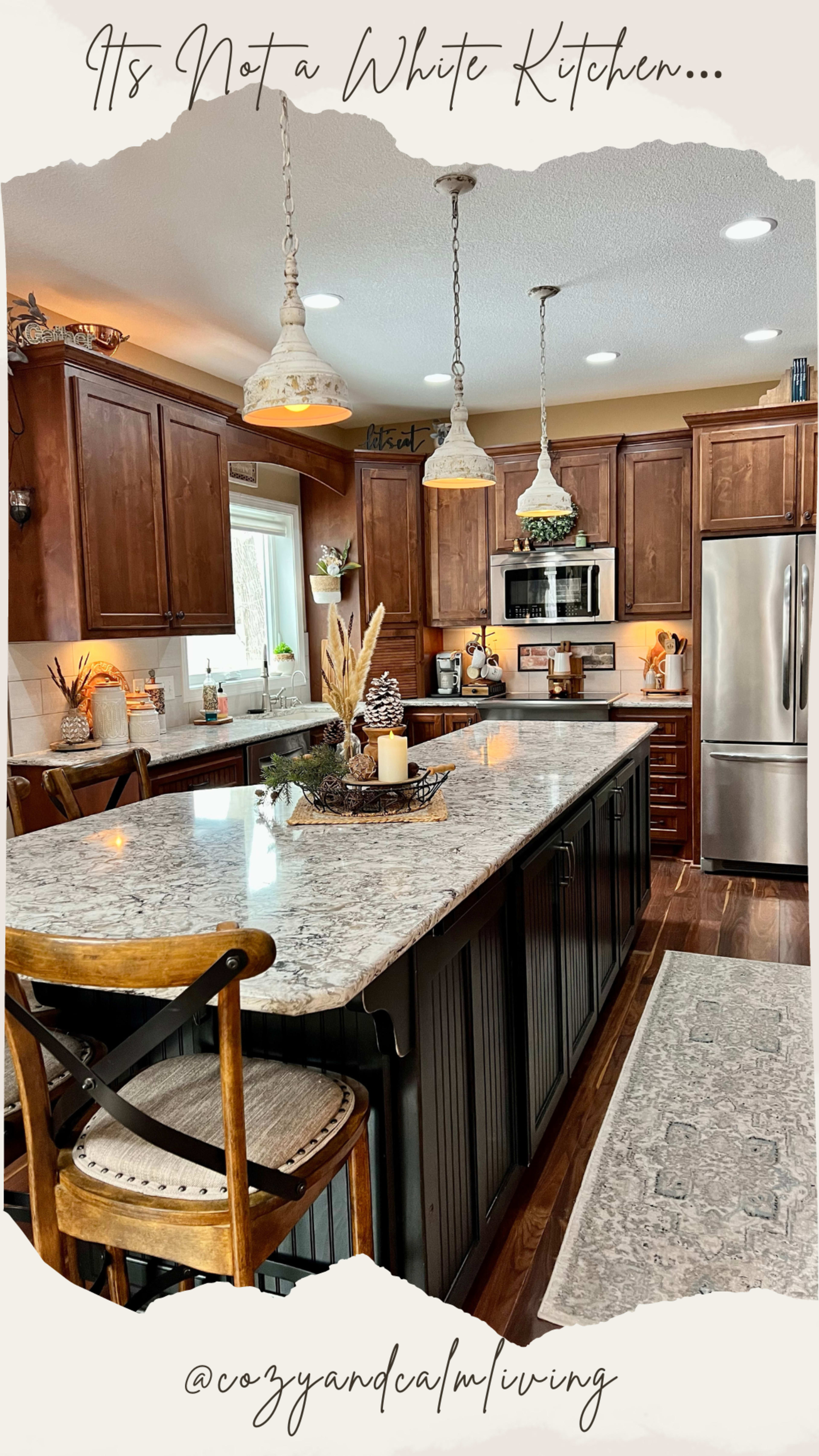 The kitchen features dark wood cabinets, a large granite island, and pendant lighting, creating a warm and inviting atmosphere.