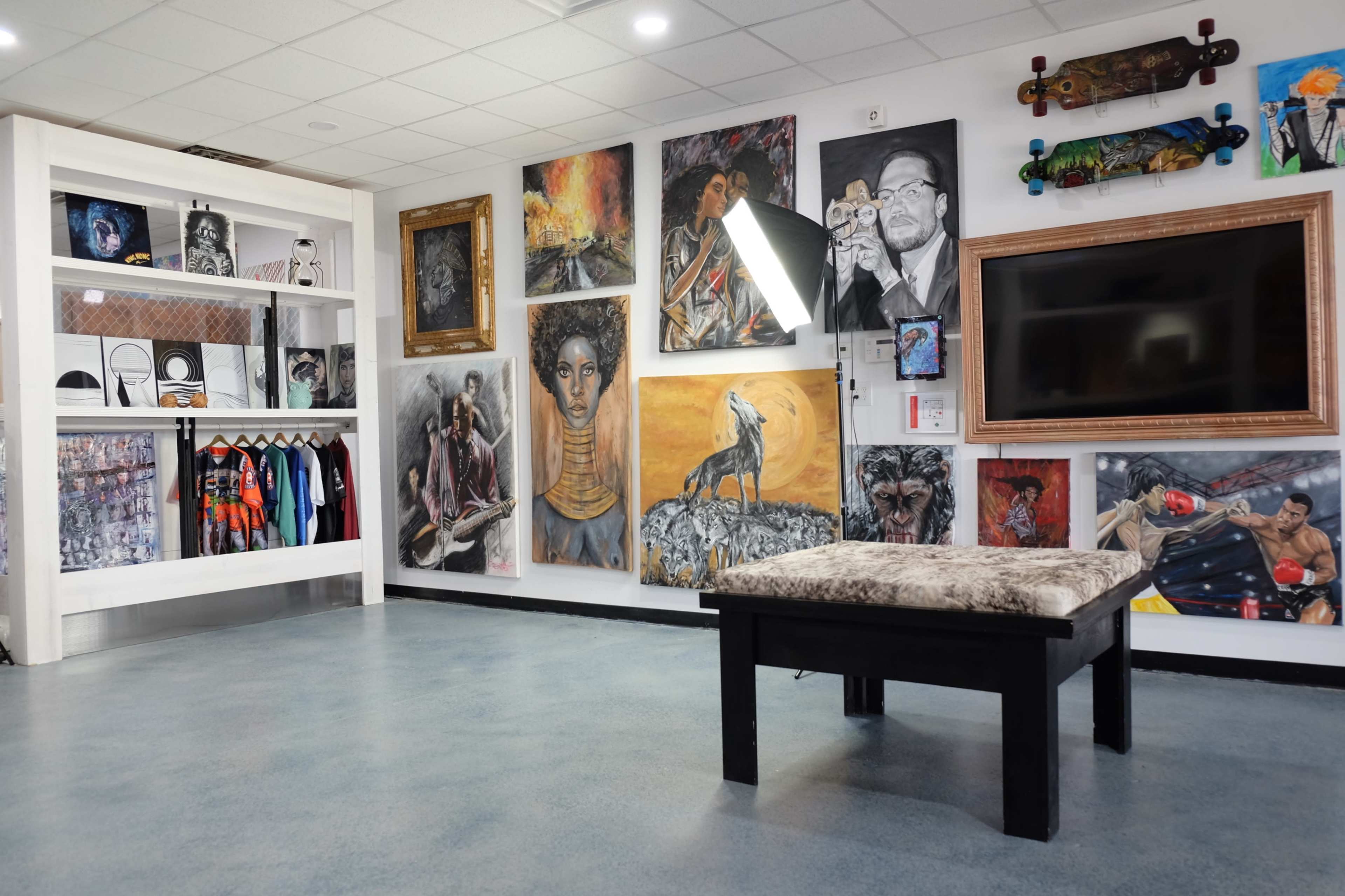 The scene features an art gallery-like space with various paintings on the walls, a display of clothing, and a large screen mounted on one side.