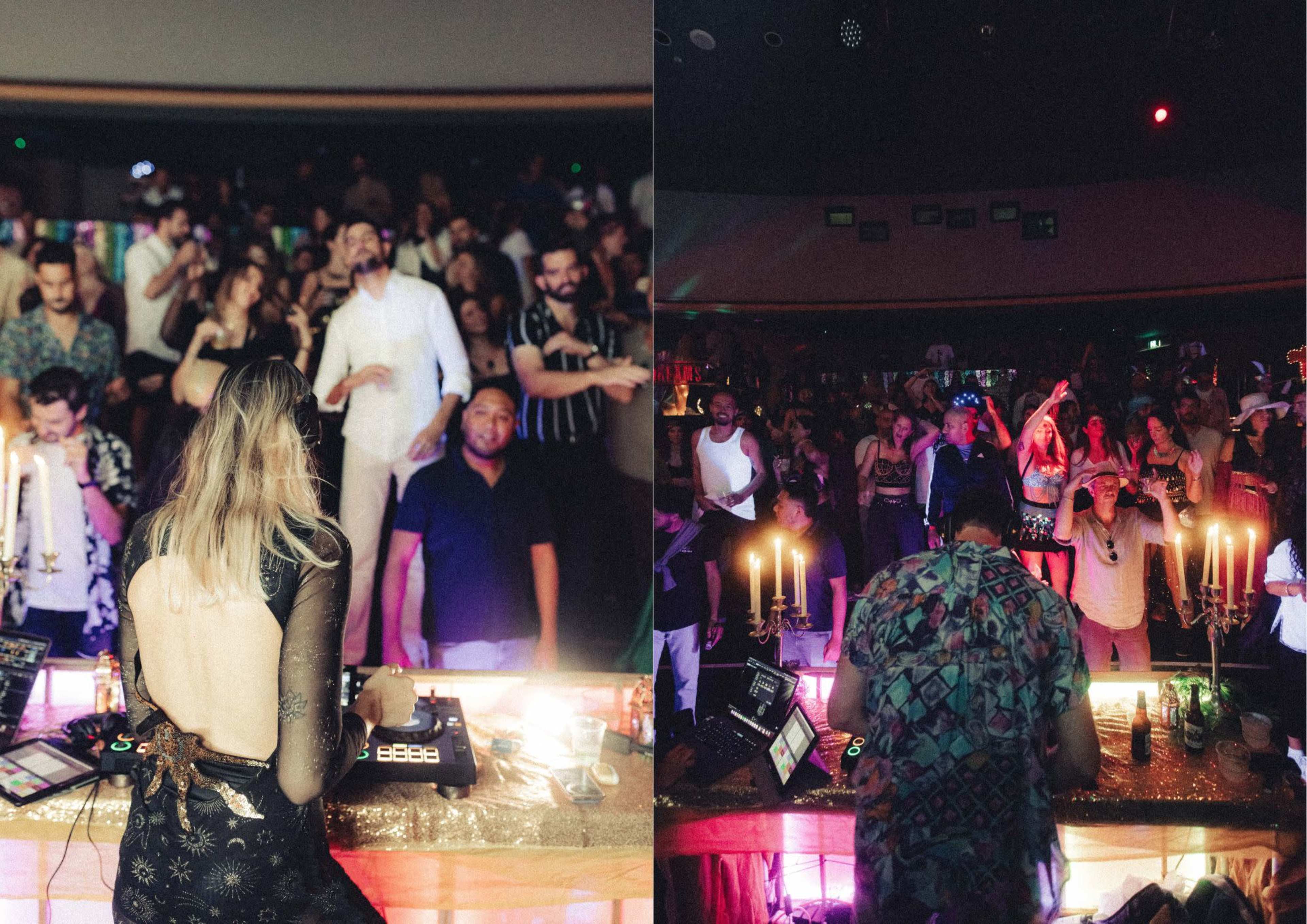 A DJ performs in front of a crowded dance floor, illuminated by colorful lights and surrounded by people dancing.
