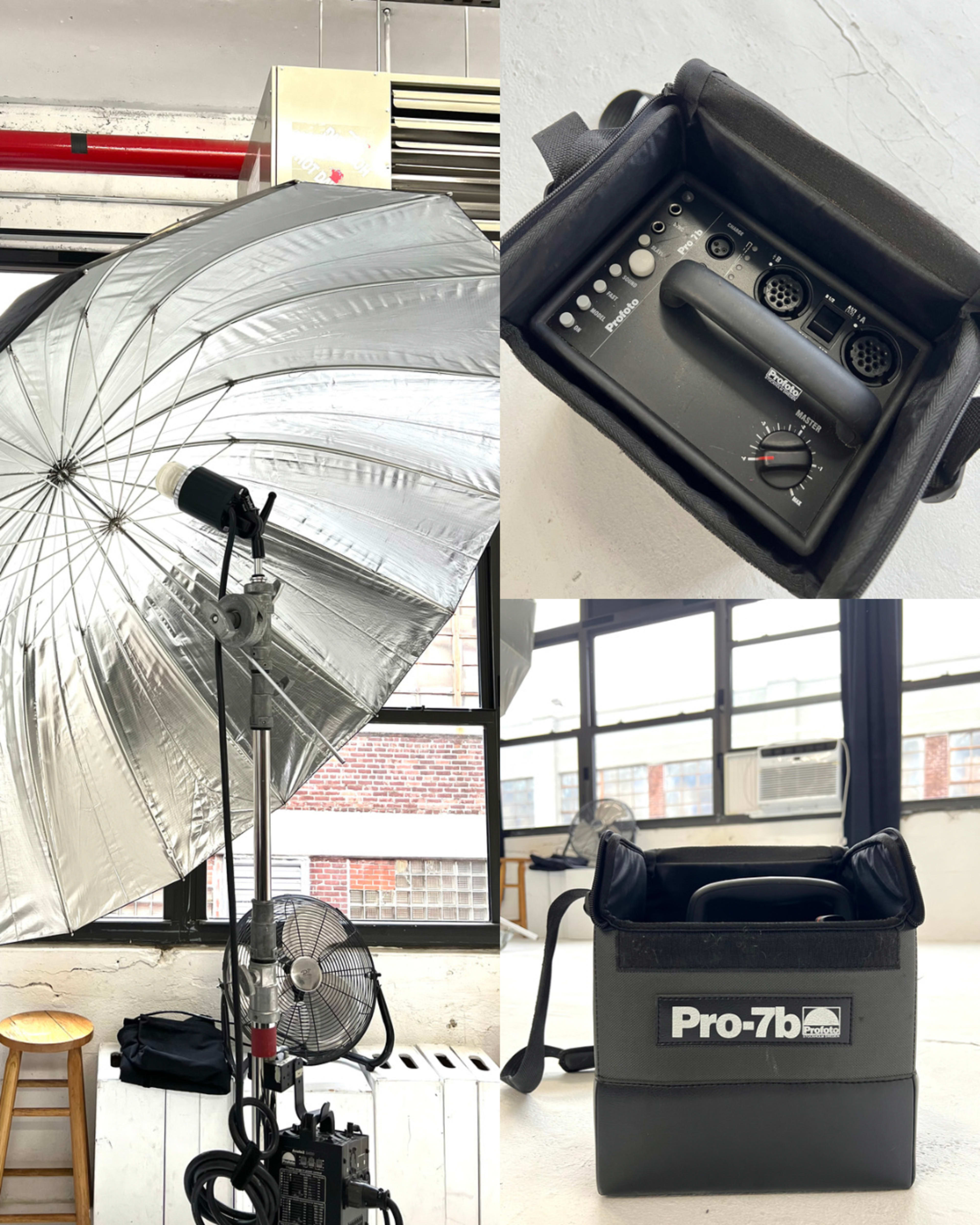 The image showcases a photography studio setup featuring a large umbrella softbox, a control device with audio inputs, and a bag labeled "Pro-7b" used for lighting equipment.