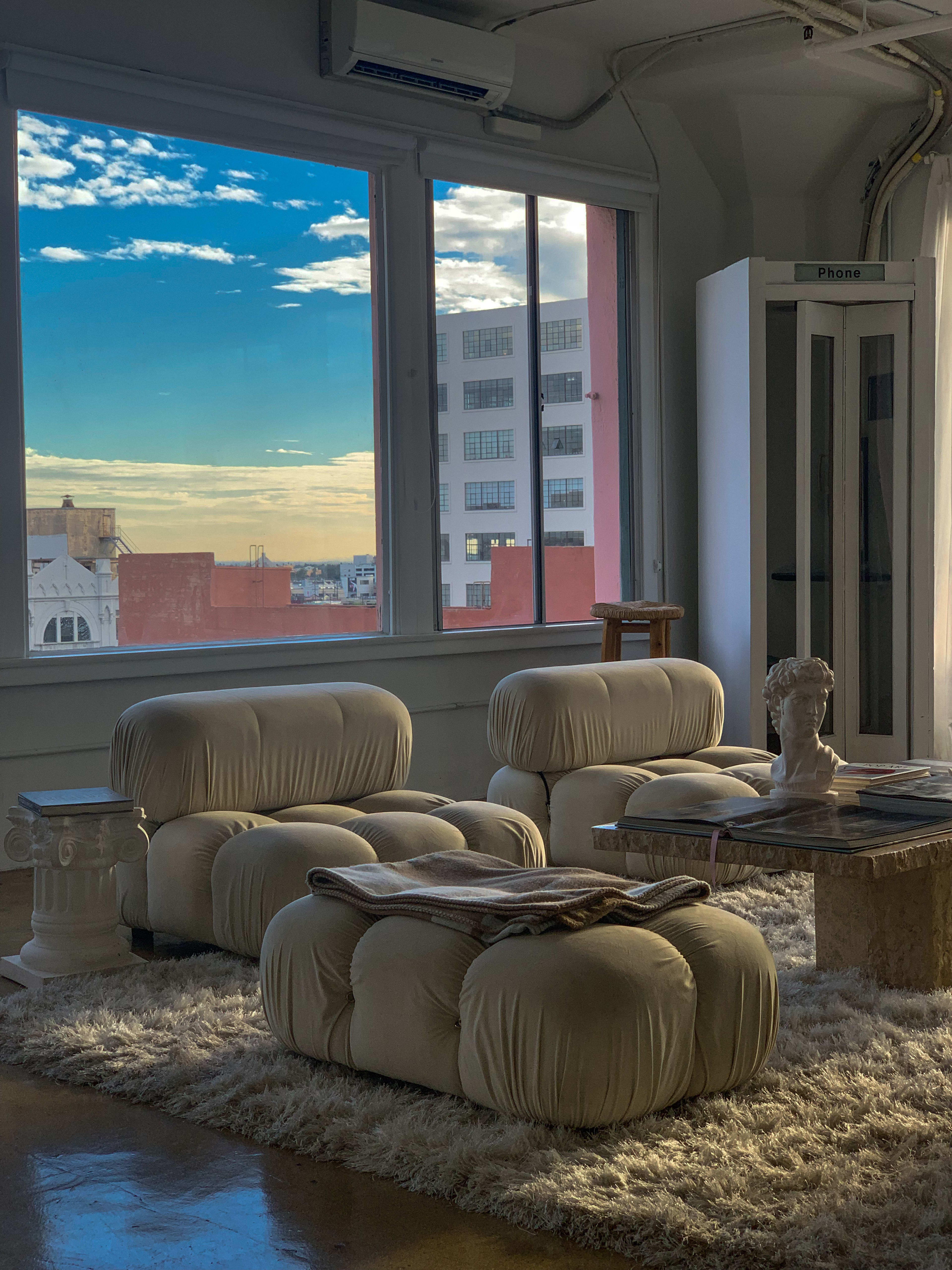 A beige living room with furniture for a product photoshoot.