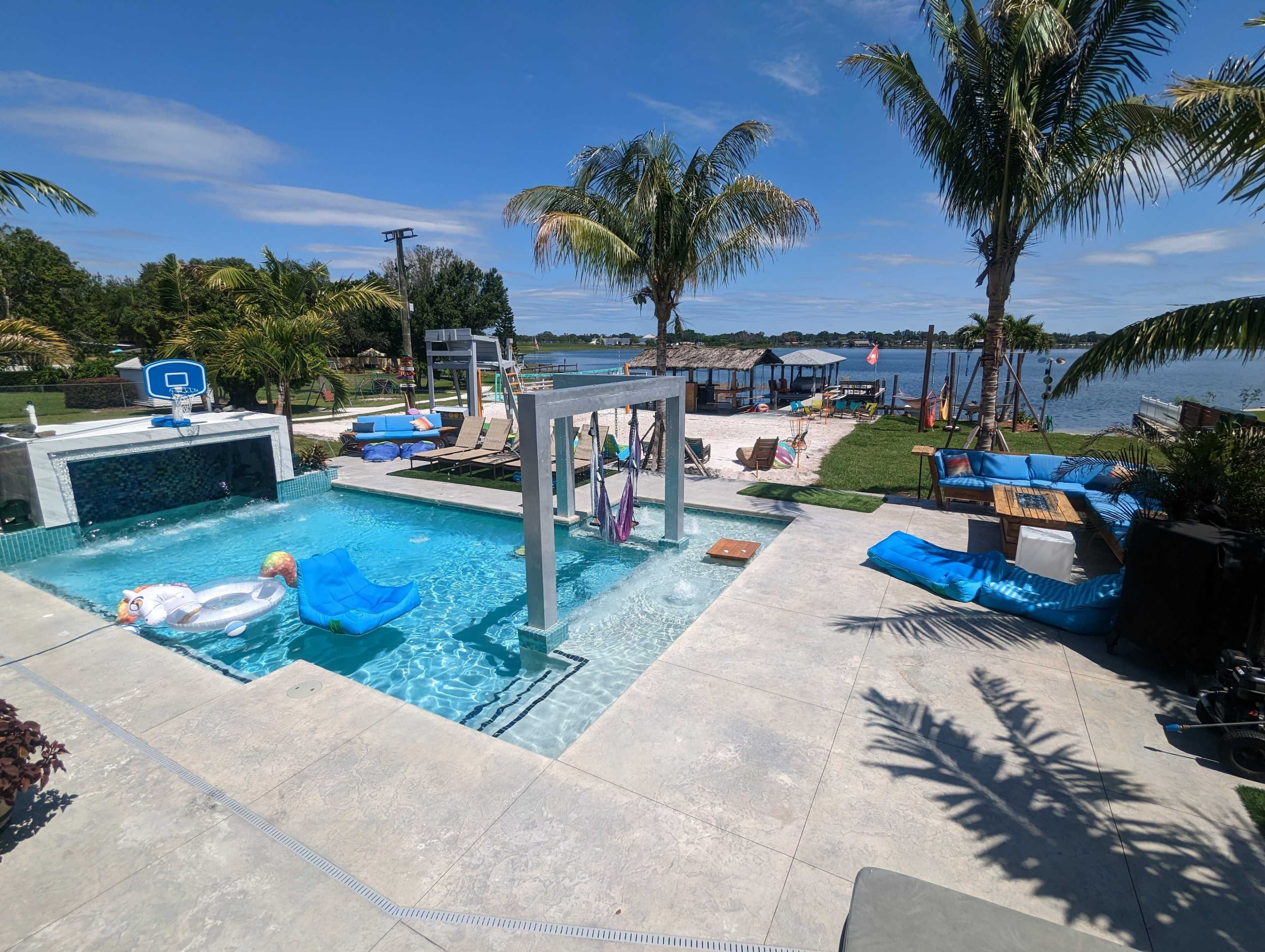 Lakefront grotto Palm Oasis, Sand Volleyball, and Custom Pool Features Image in , Orlando, FL
