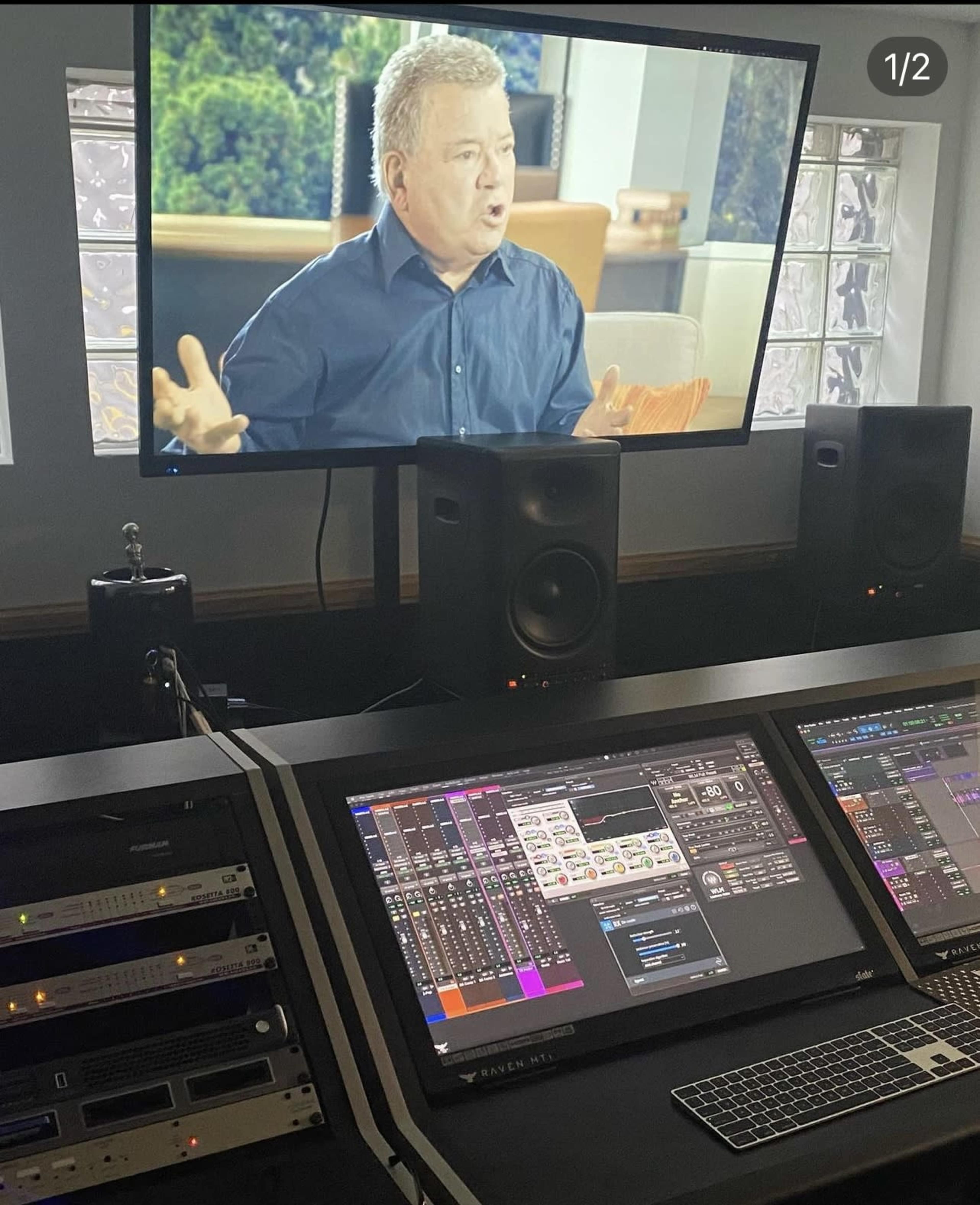 The image shows a sound editing studio with a computer interface displaying audio tracks and a television screen featuring a man speaking.