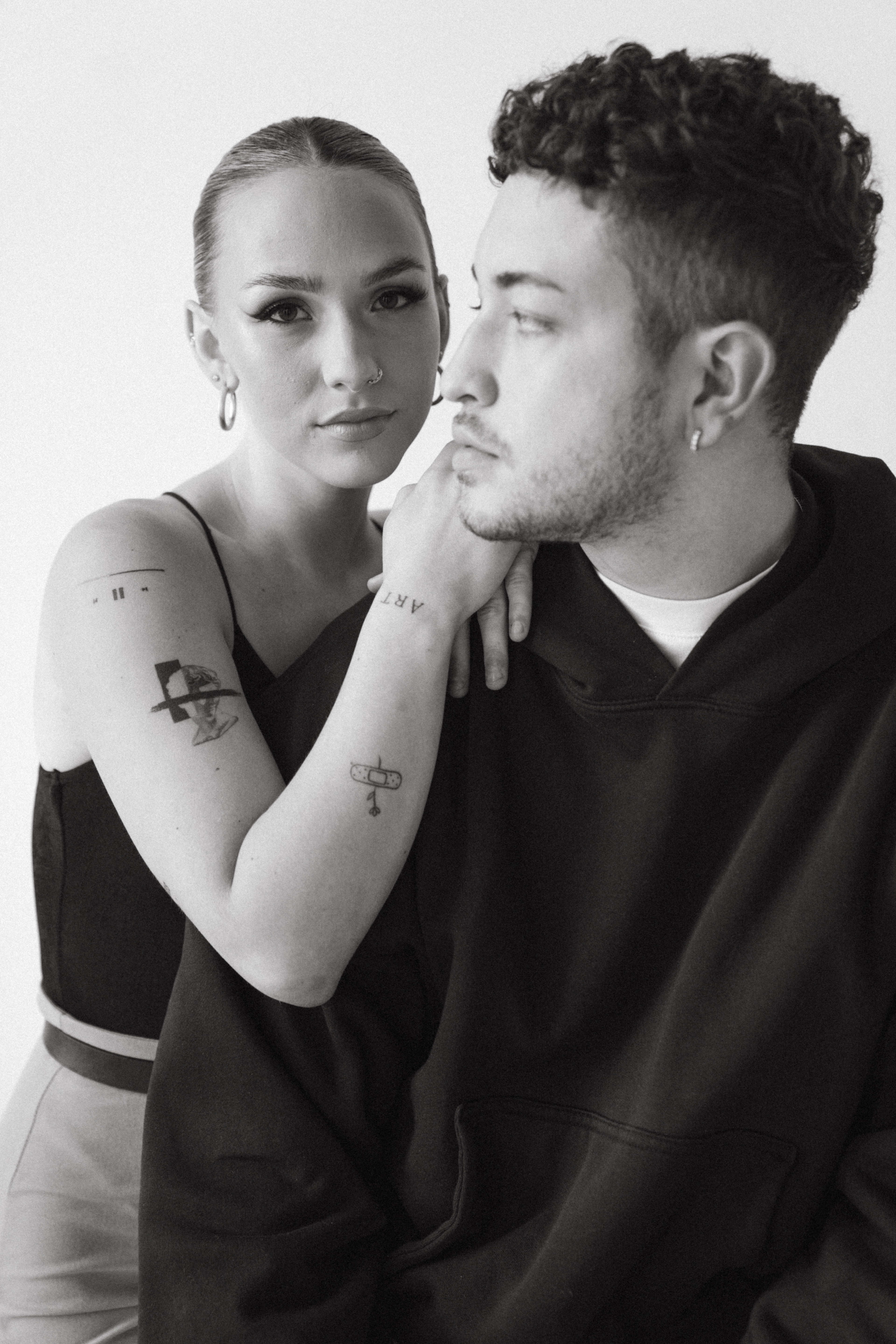 A black and white photo shoot featuring a man and a woman sitting next