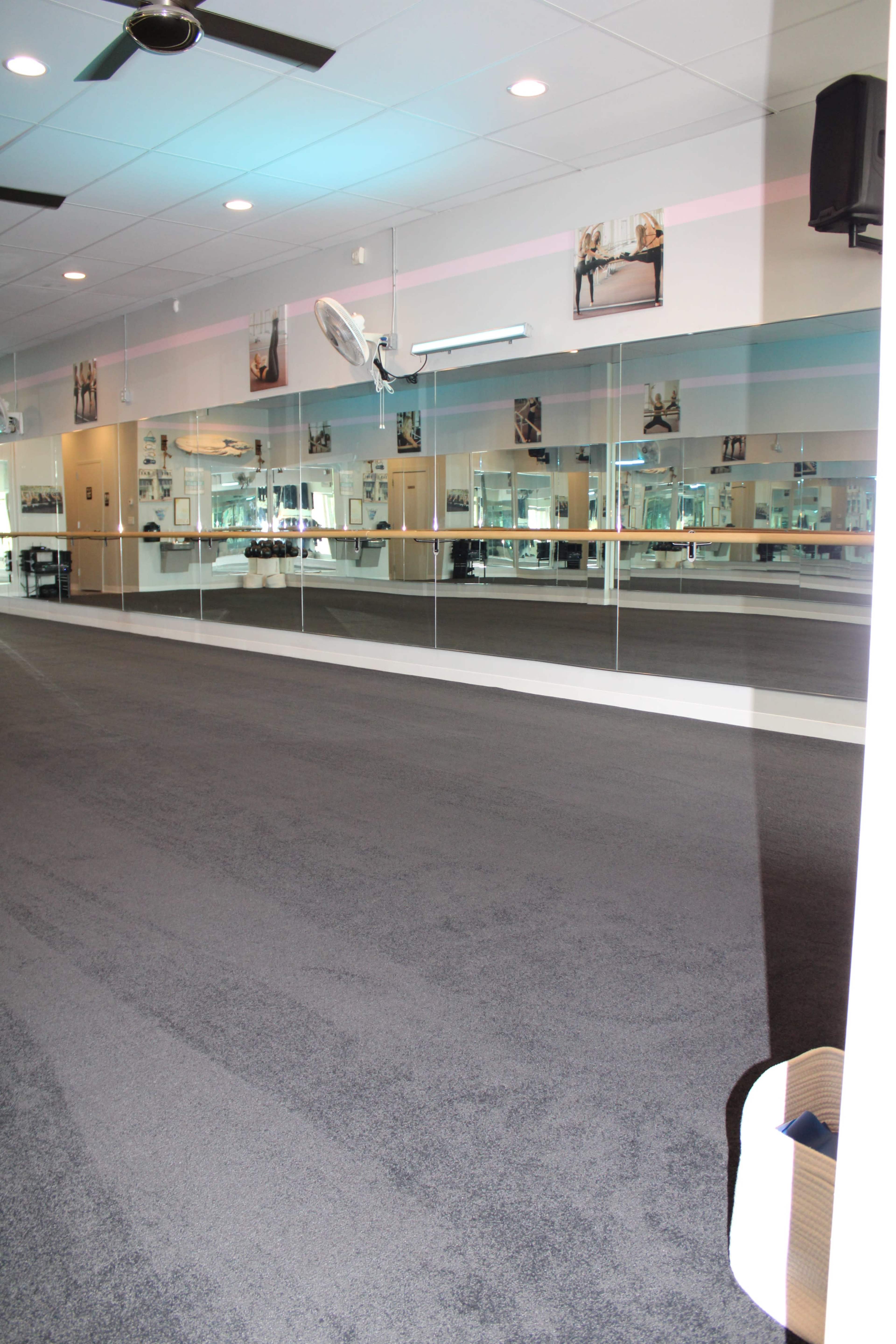 Urban area, open carpeted studio space for fitness, movement, dance, stretching, and more, comfortable and homey yet open, studio space, lobby and office area. Image in Lawrence, Lawrence, KS