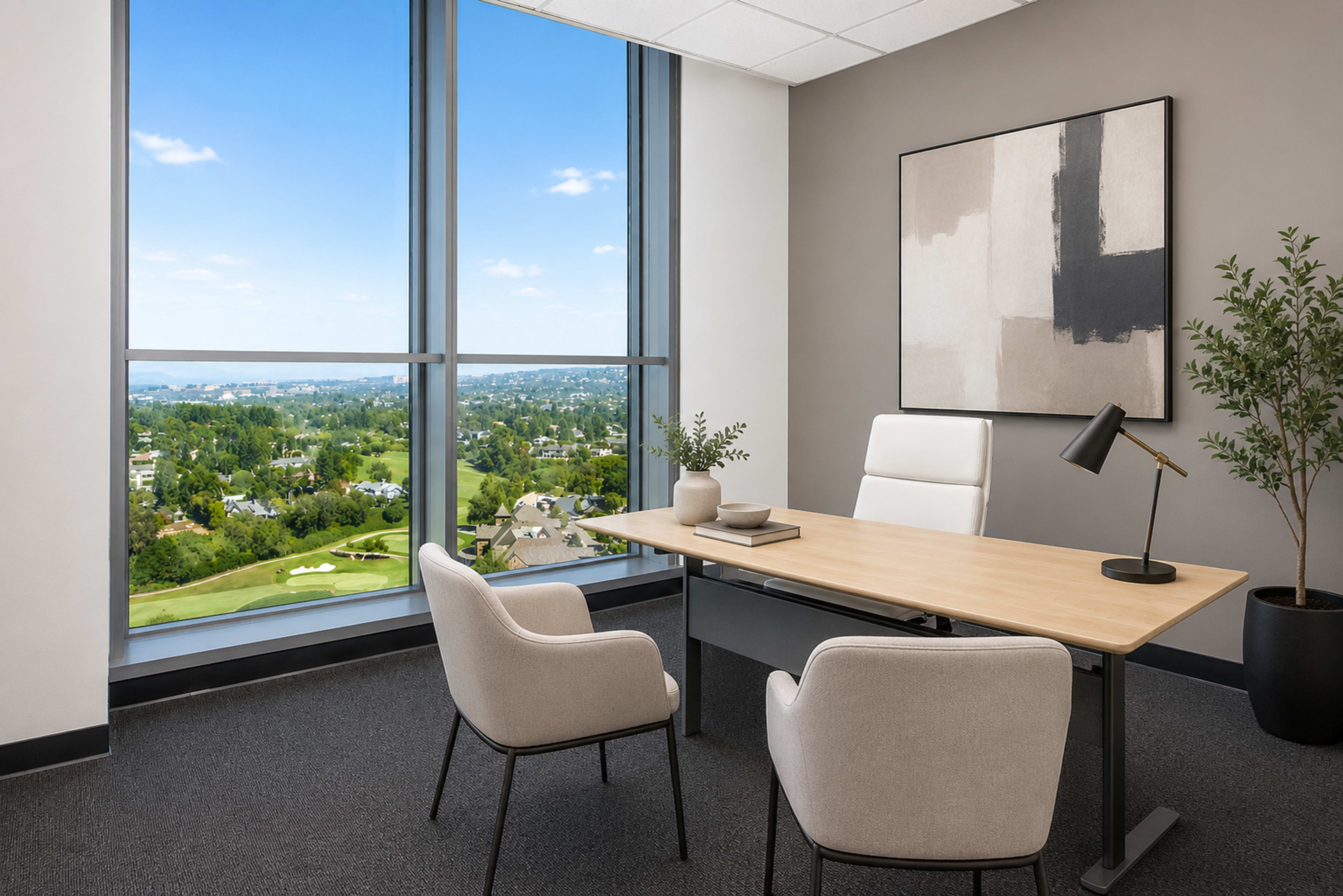 A modern office features a wooden desk with two chairs and a large window overlooking a green landscape and blue sky.