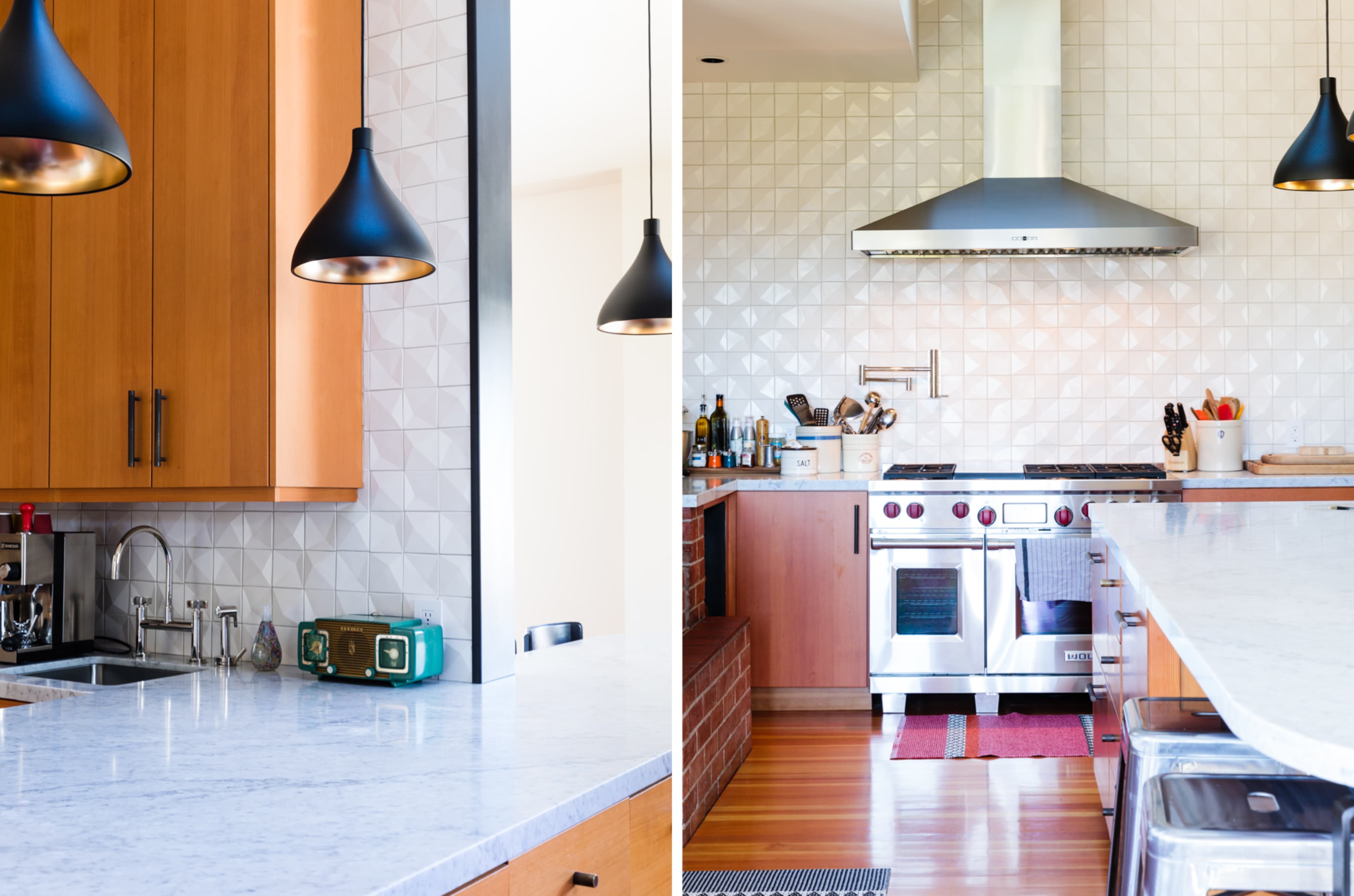 The image shows a modern kitchen with wooden cabinets, a marble countertop, and a stainless steel range hood above a gas stove.