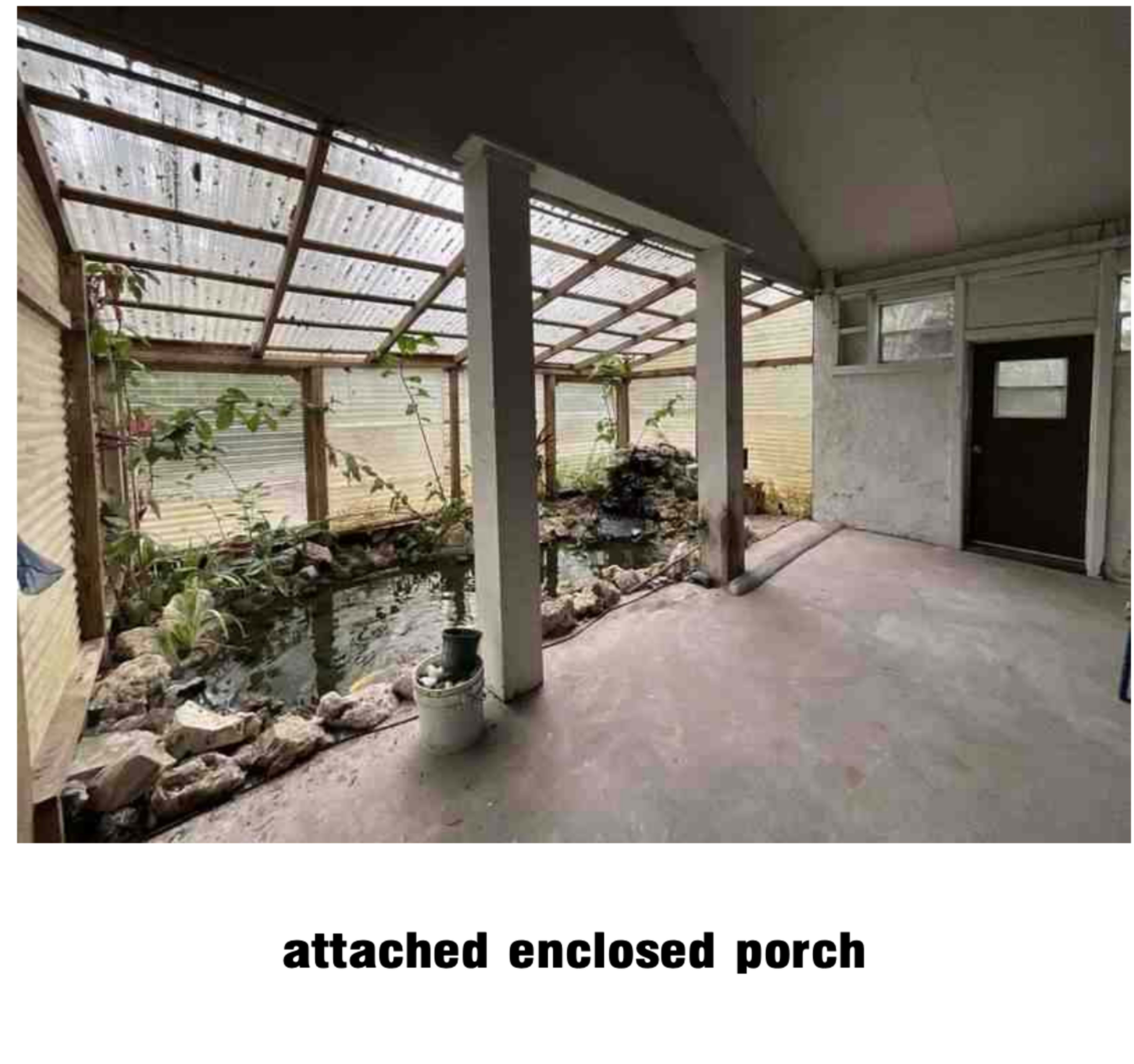 The image shows an attached enclosed porch with a small pond and plants alongside the walls.