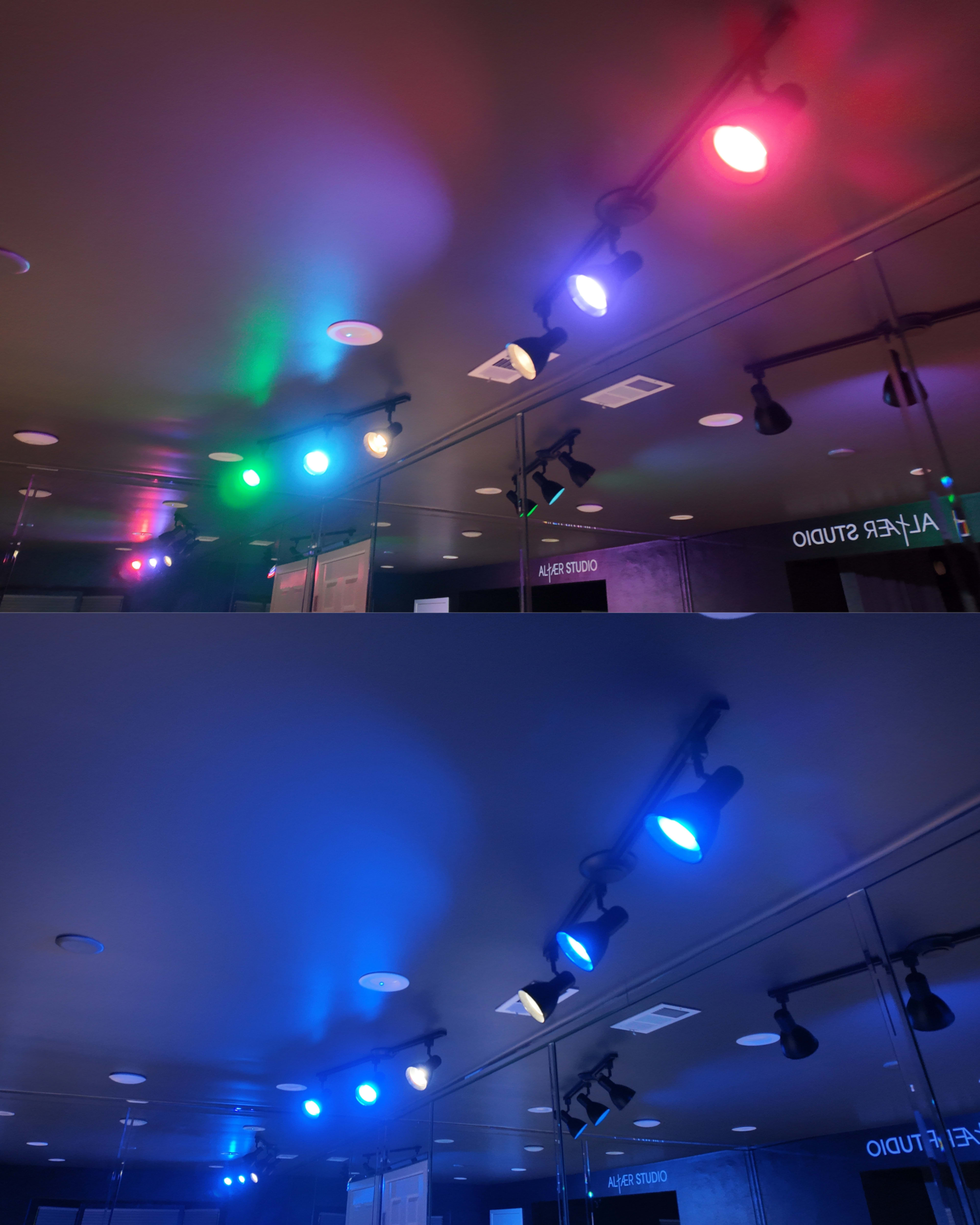 The image shows two ceiling sections featuring track lighting with different colored lights, including green, blue, and red, reflecting on a mirrored surface.