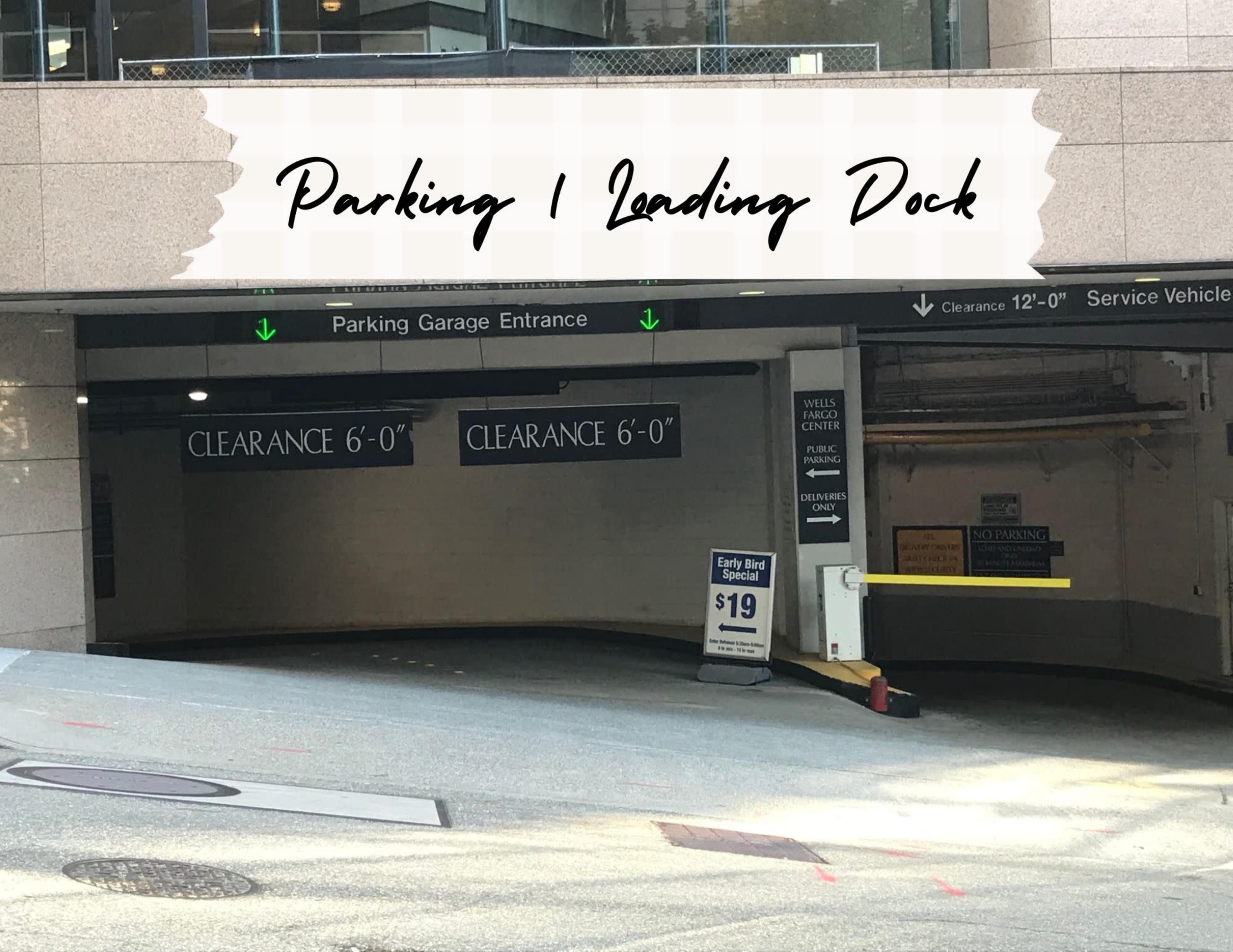 The entrance to a parking garage with signs indicating clearance heights and pricing information.