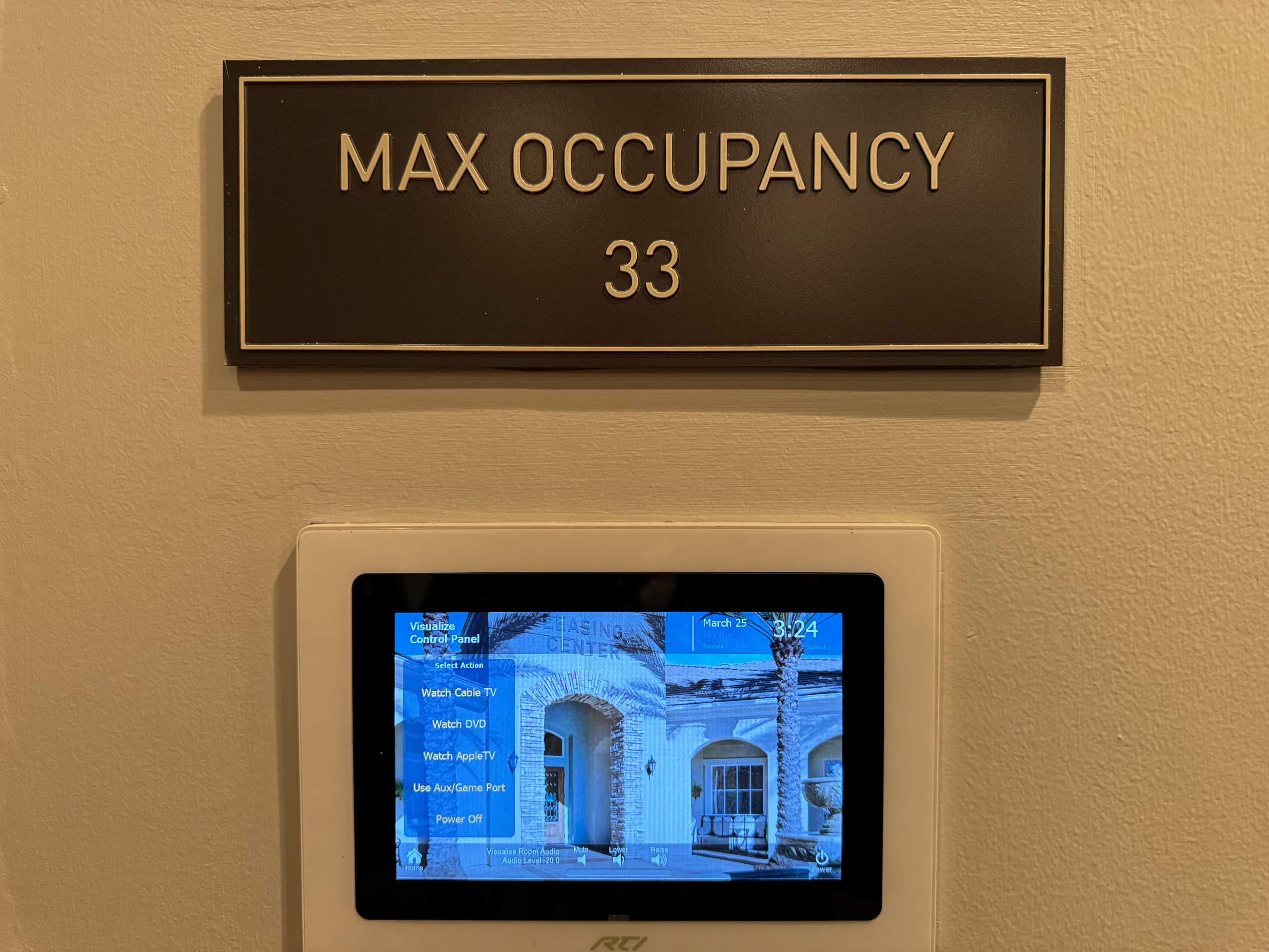 A sign displays "MAX OCCUPANCY 33" above a digital display panel showing various options.