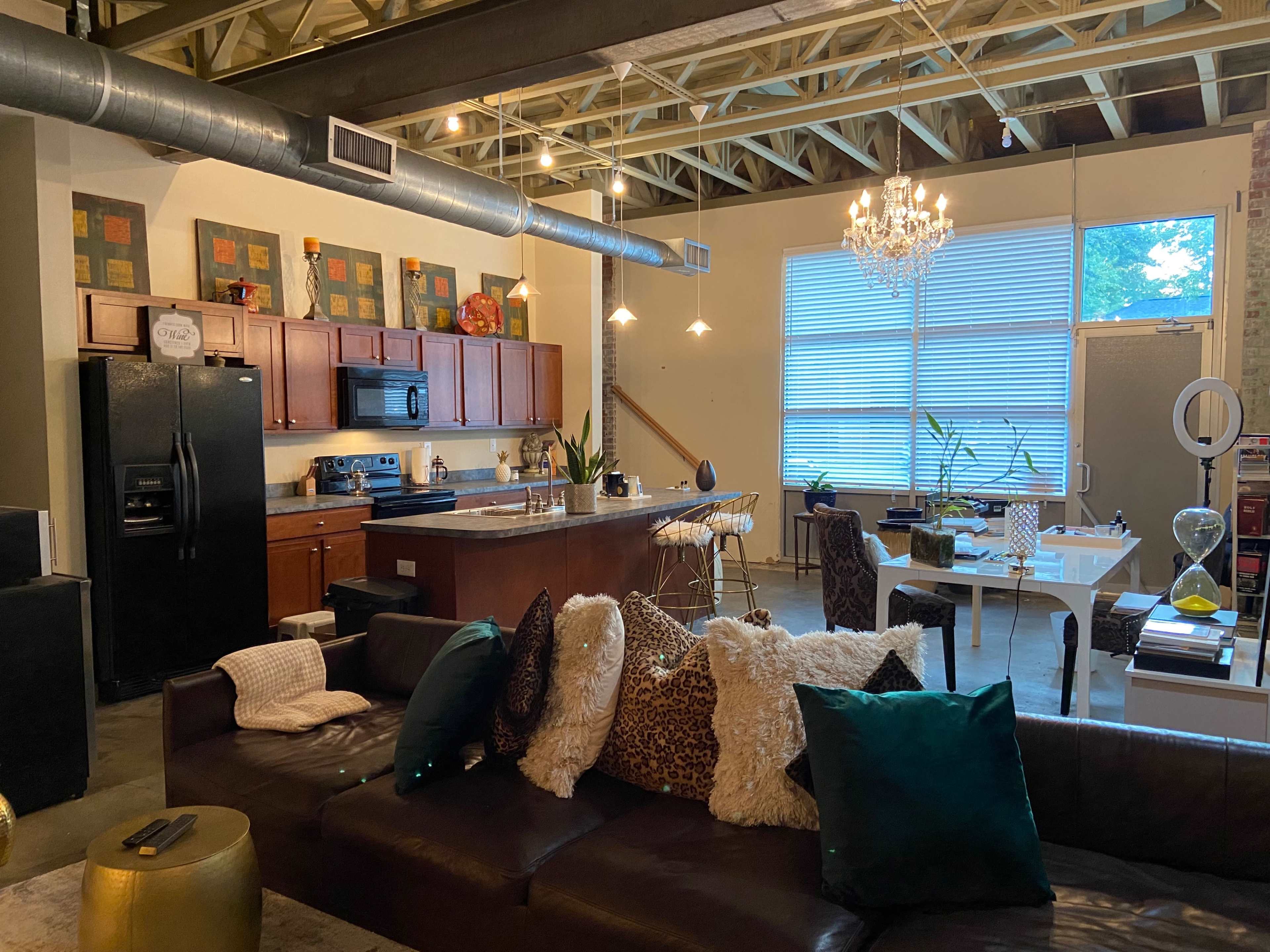 A spacious loft-style living area with a kitchen, dining space, and a comfortable seating arrangement.