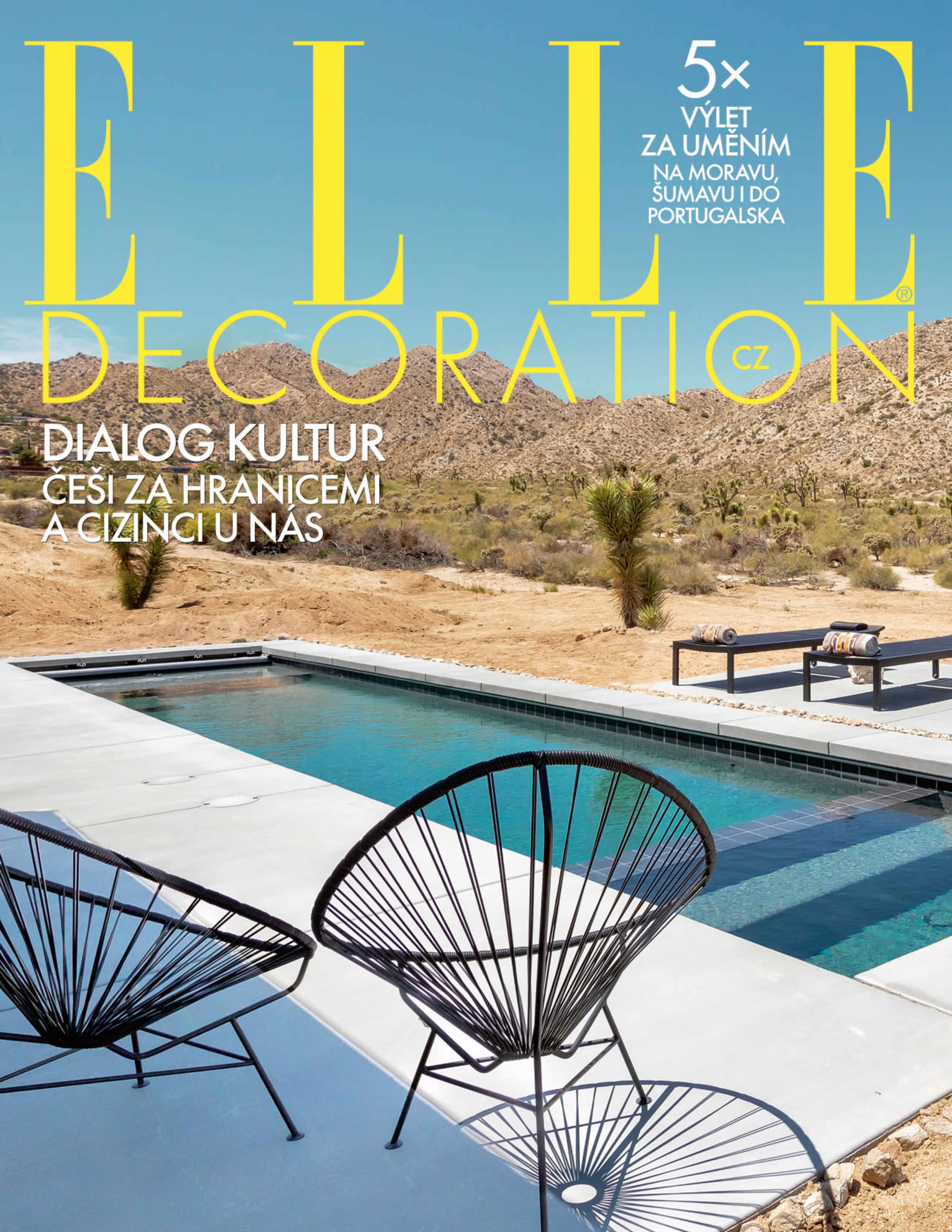 The image features a modern swimming pool surrounded by a desert landscape with mountains in the background, showcased on the cover of a design magazine.