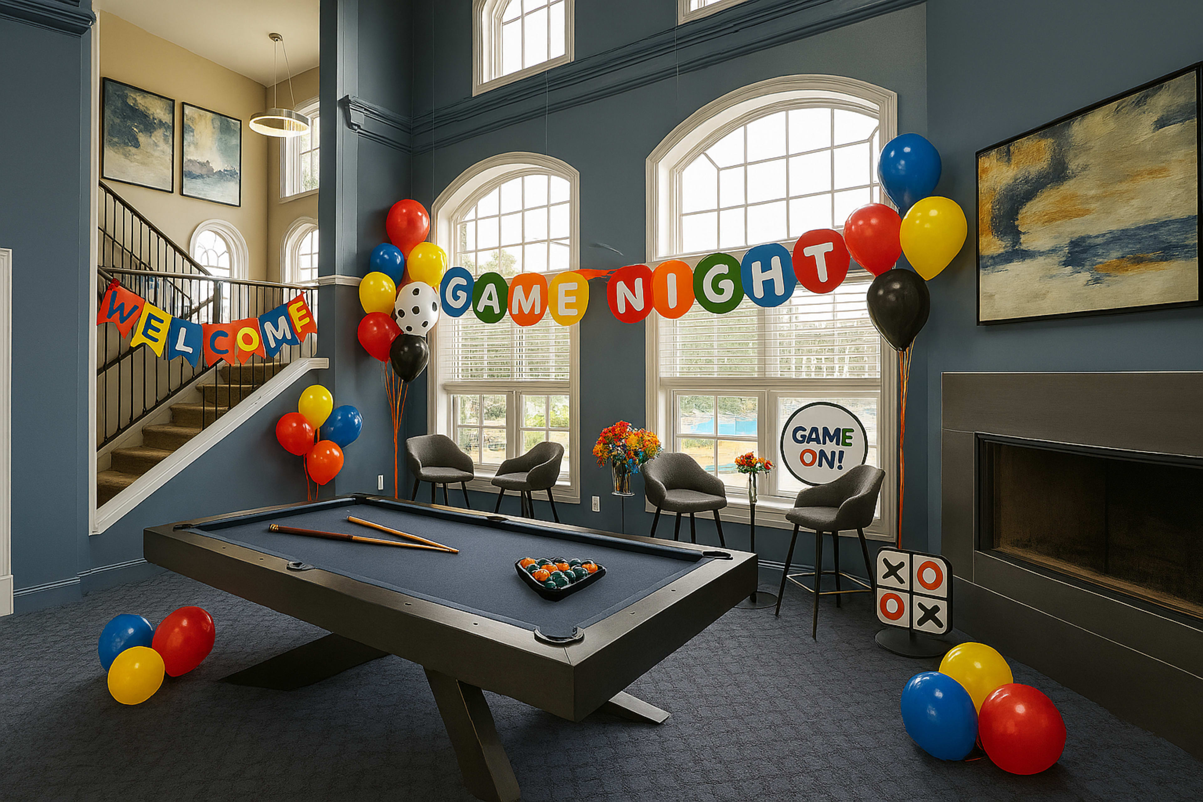 A spacious game room is decorated with colorful balloons and banners for a game night, featuring a pool table, a fireplace, and large windows.