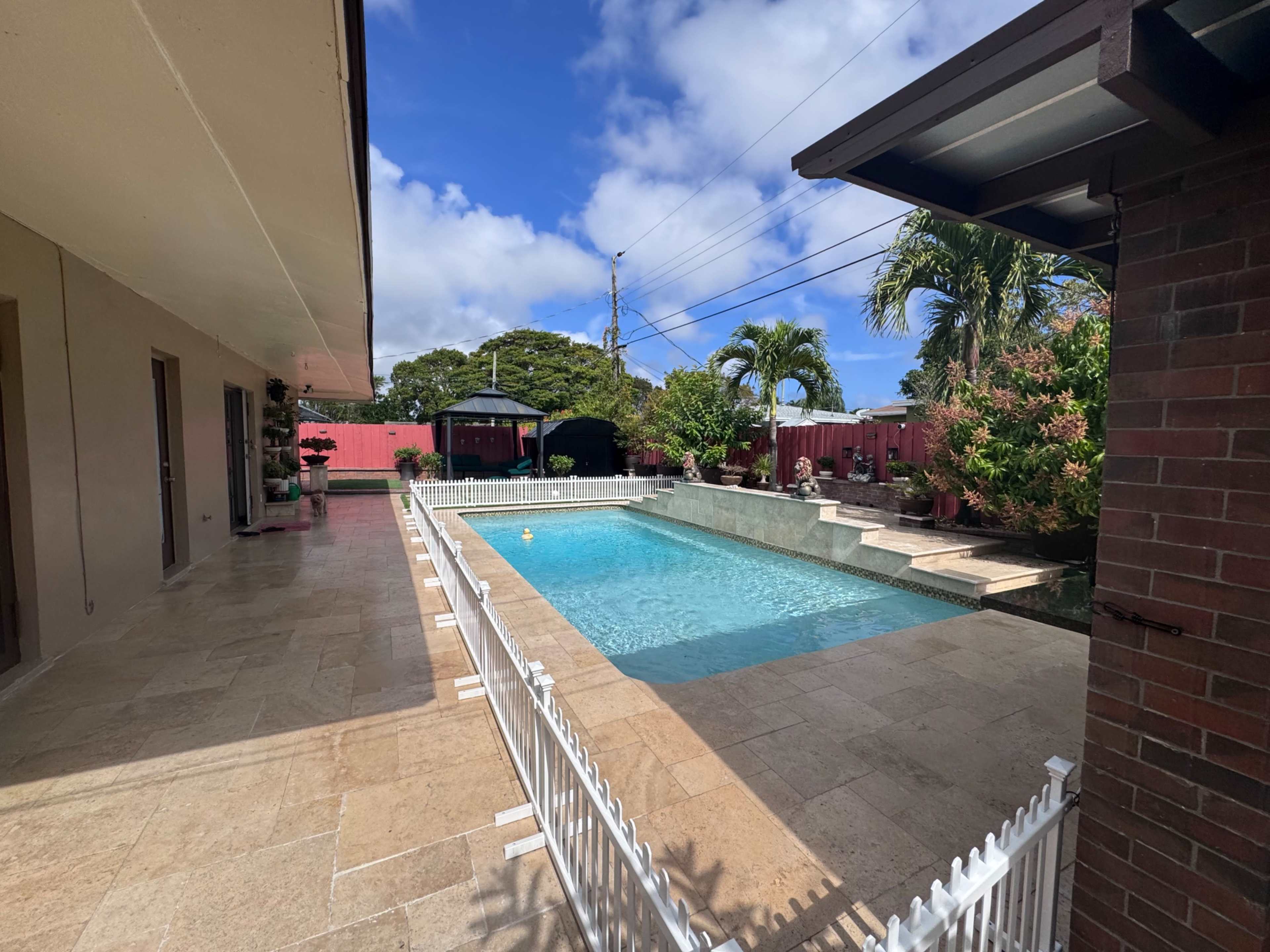 Spacious Backyard with Pool and Outdoor Kitchen Image in Pompano Beach, Pompano Beach, FL