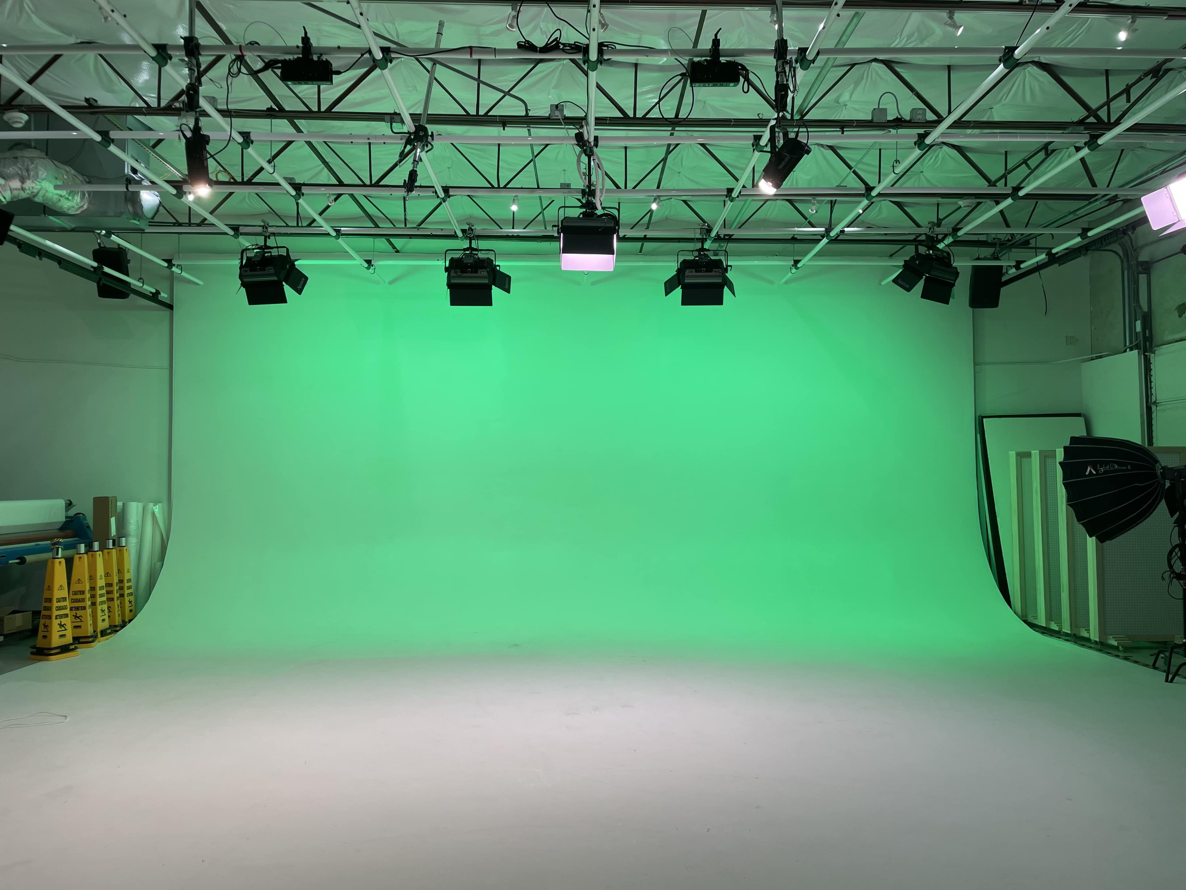 A green screen studio with bright lighting and a smooth background.