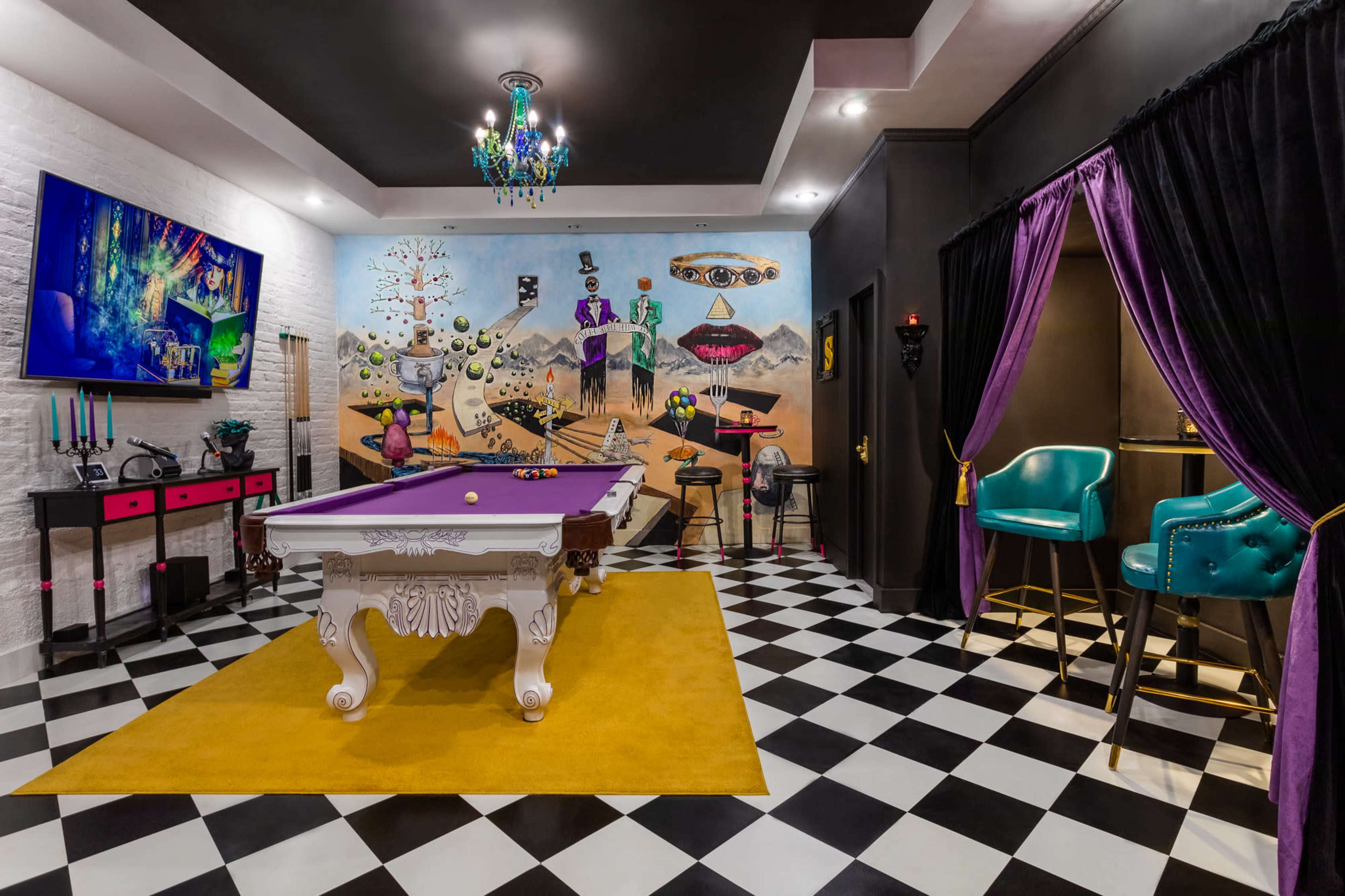 A vibrant game room featuring a purple billiard table, a colorful mural on the wall, and a black-and-white checkered floor.