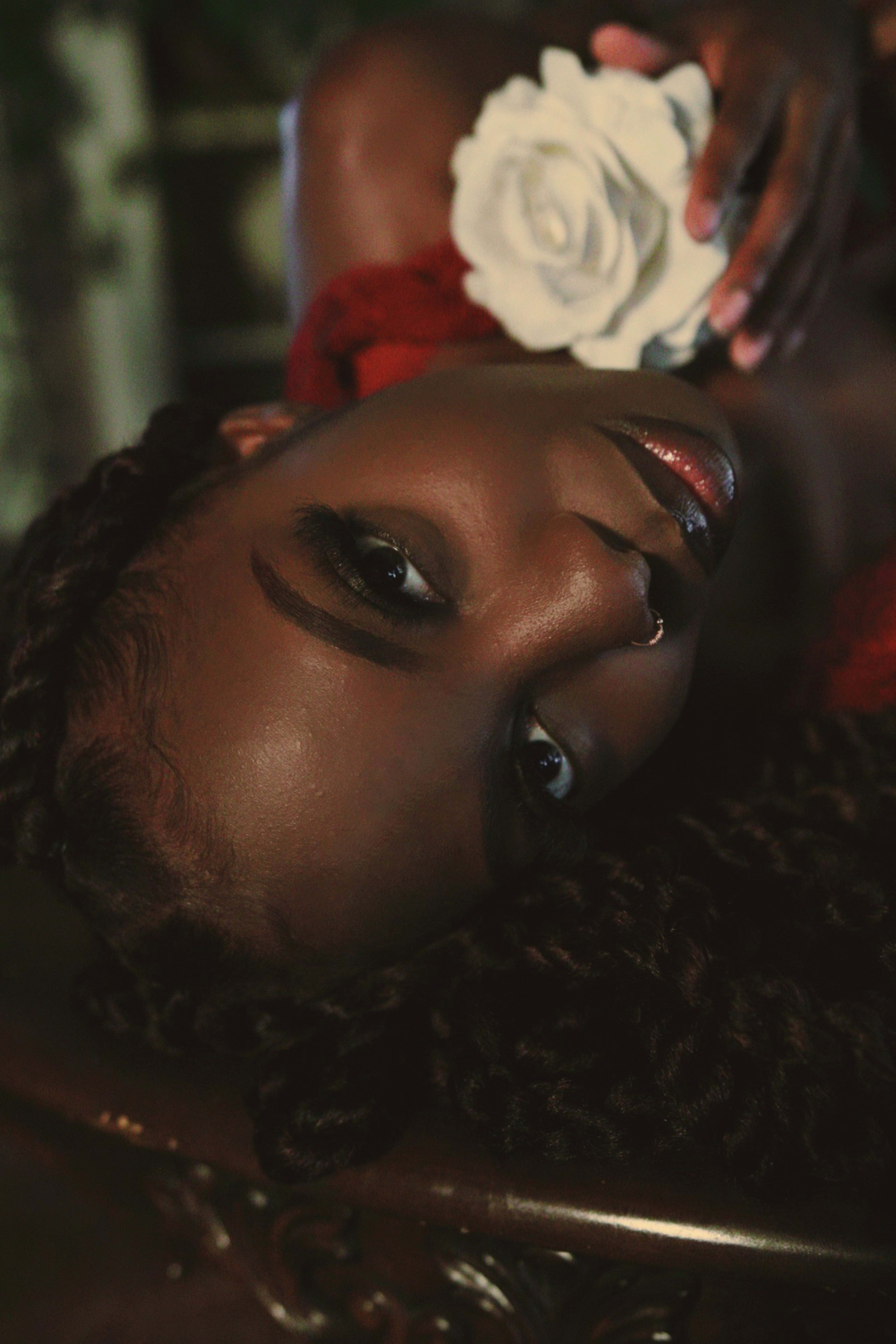 A woman lying down with a white flower