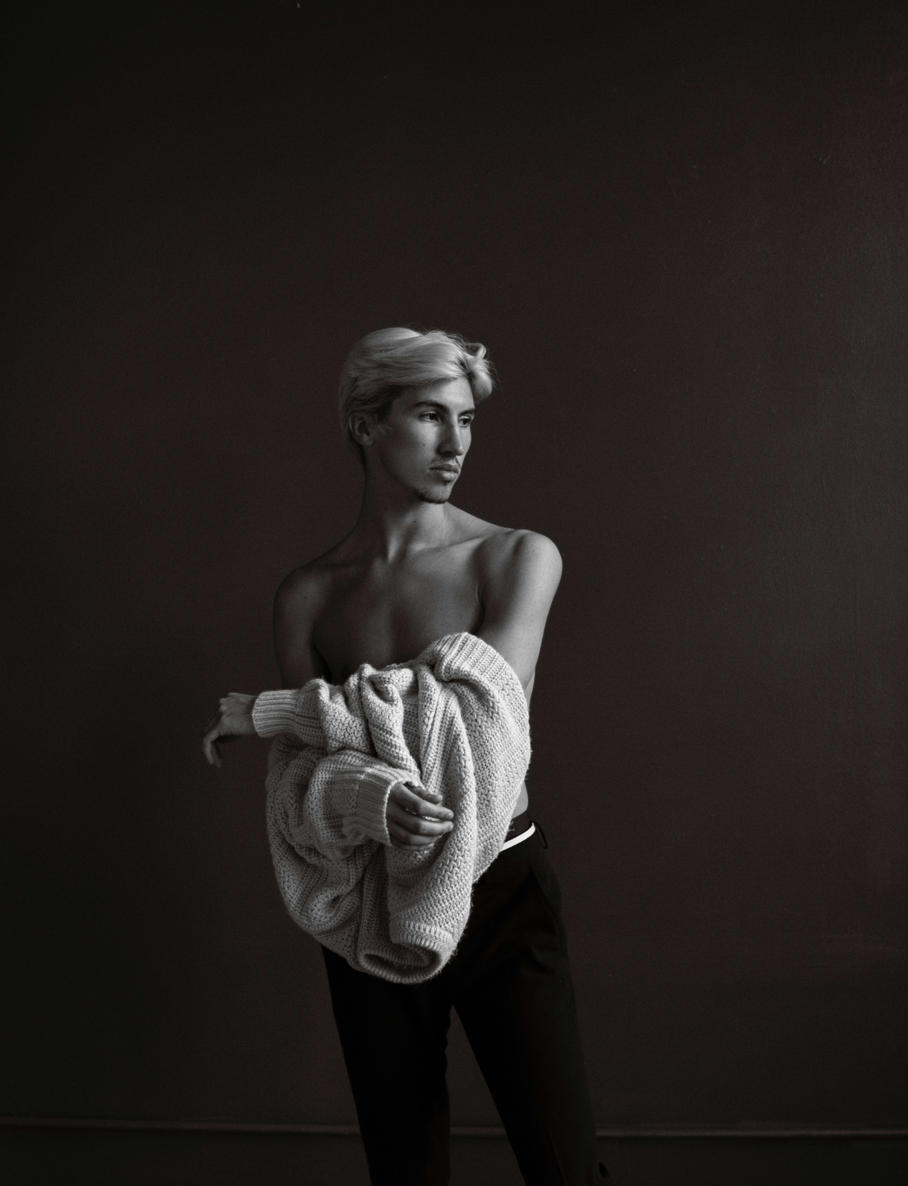 A black and white fashion photo shoot featuring a person holding a towel.