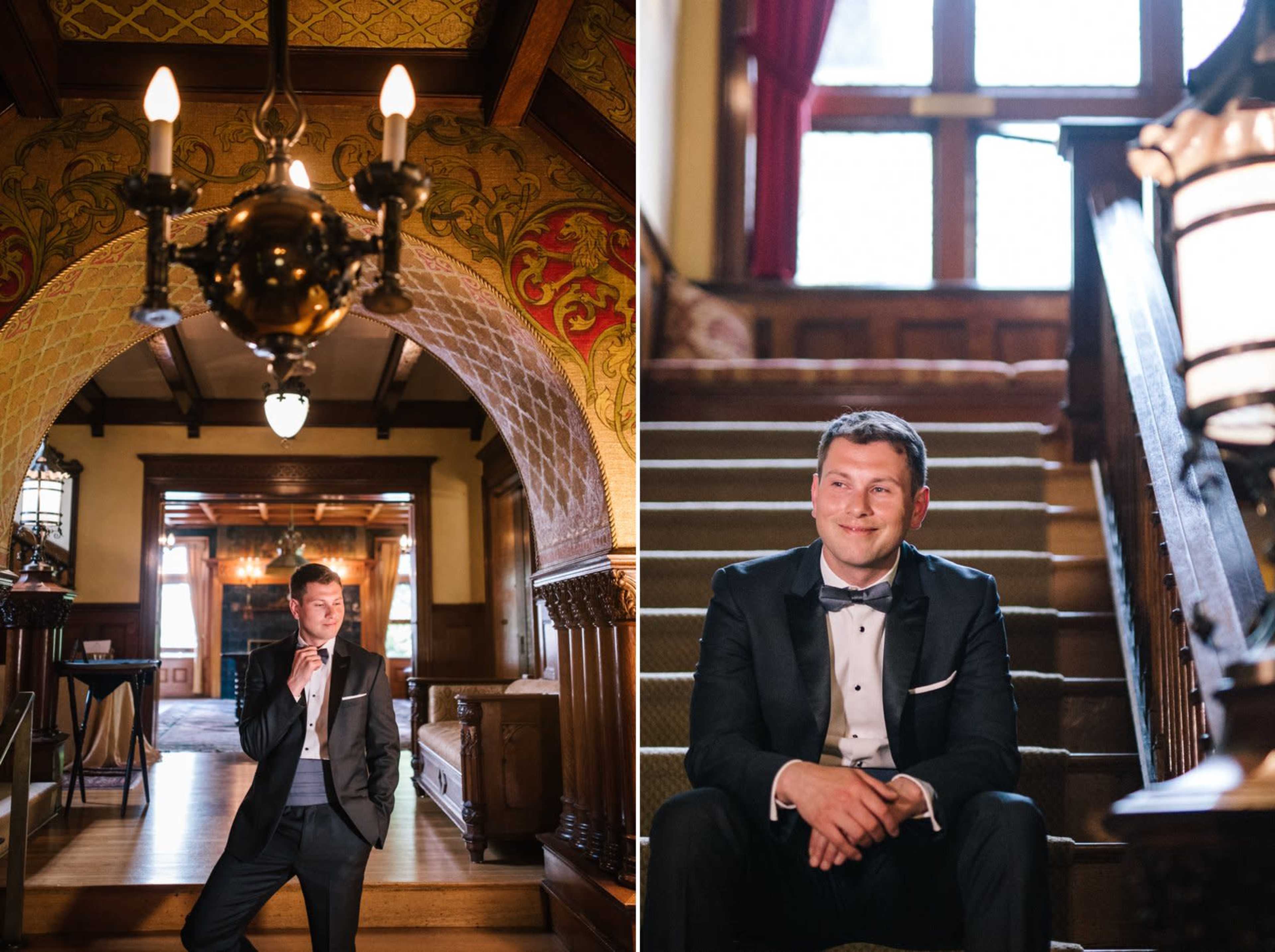 A man in a tuxedo poses elegantly on the stairs of a grand staircase in a historic mansion, with ornate lighting and woodwork surrounding him.