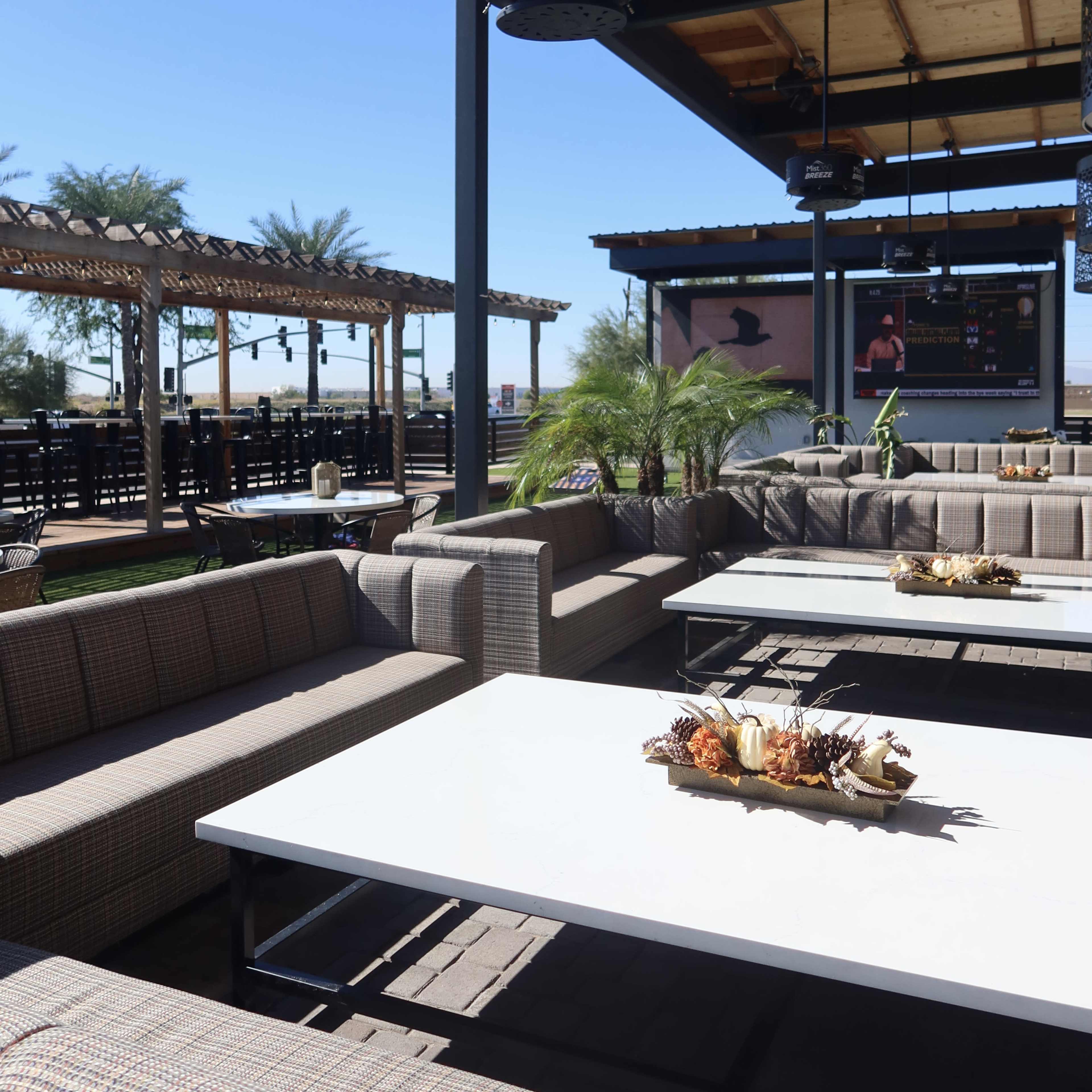 Modern Outdoor Lounge with Couches and Lush Plants Image in Park West, Peoria, AZ