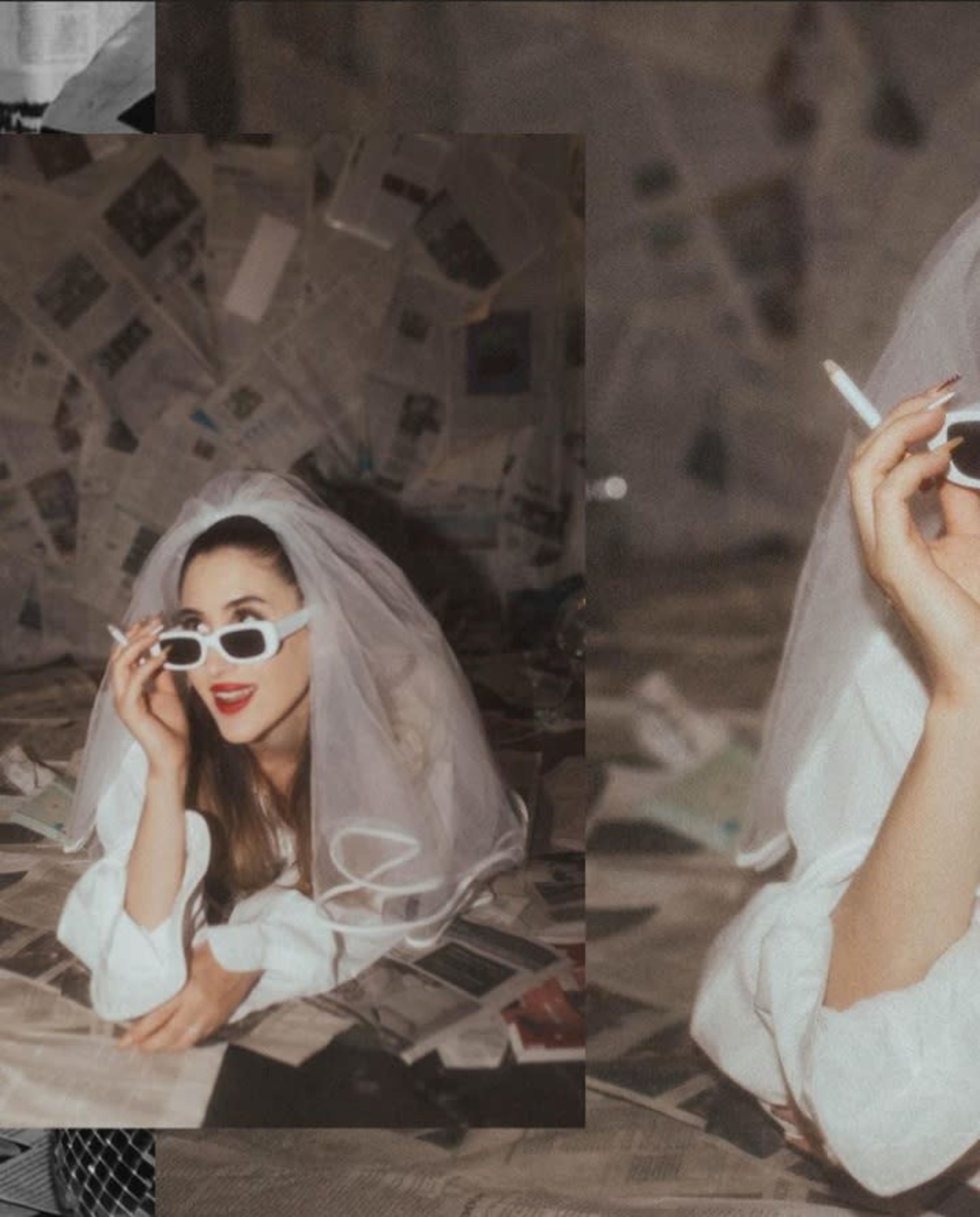 A woman in a white veil and sunglasses lies among scattered newspaper pages while holding a cigarette.