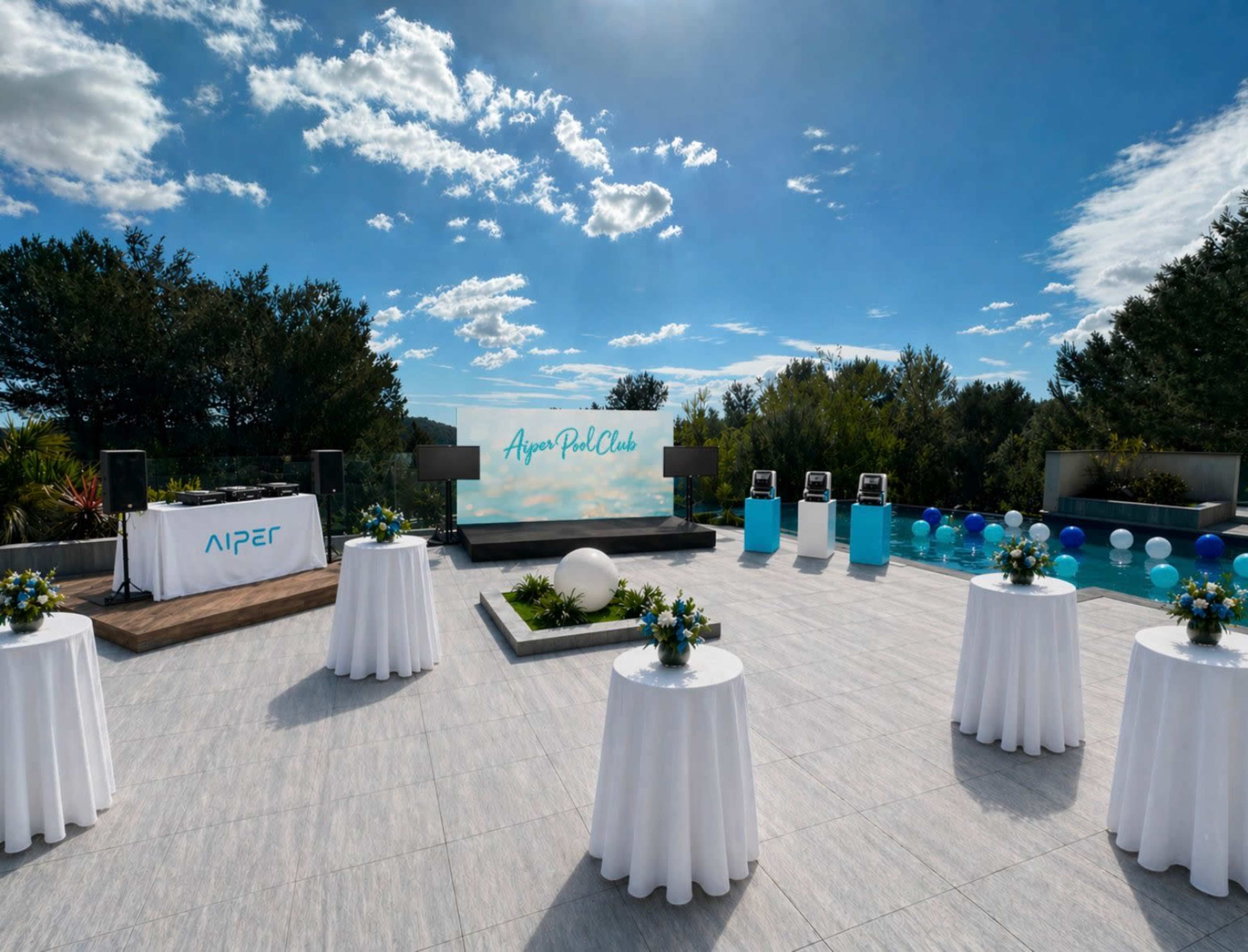 The image depicts an outdoor event space featuring several round tables with floral centerpieces, a large screen displaying "Aspen Pool Club," and a swimming pool surrounded by trees under a blue sky with clouds.