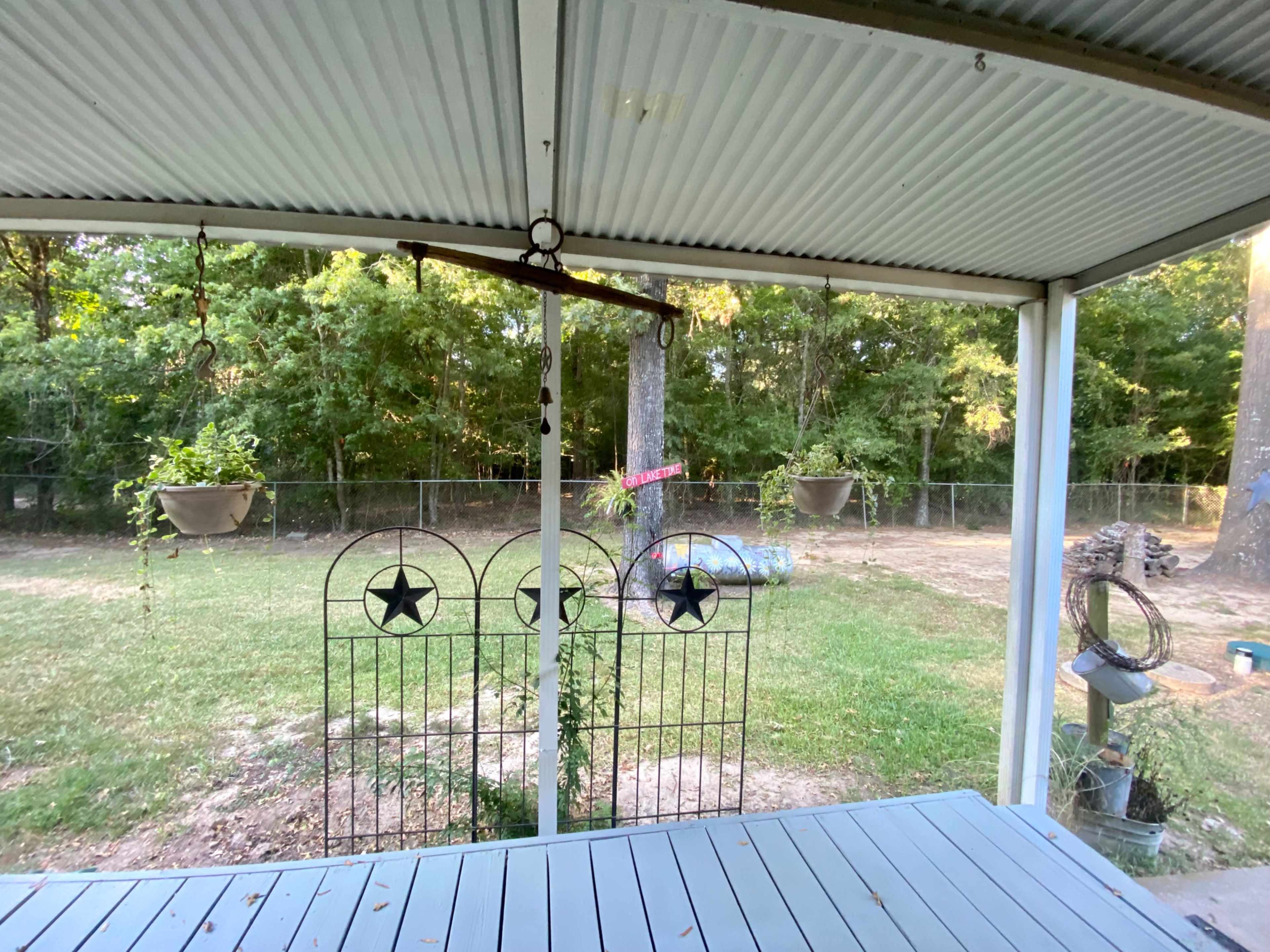 Lake area home with large gazebo and fenced backyard. Image in West Livingston, Livingston, TX