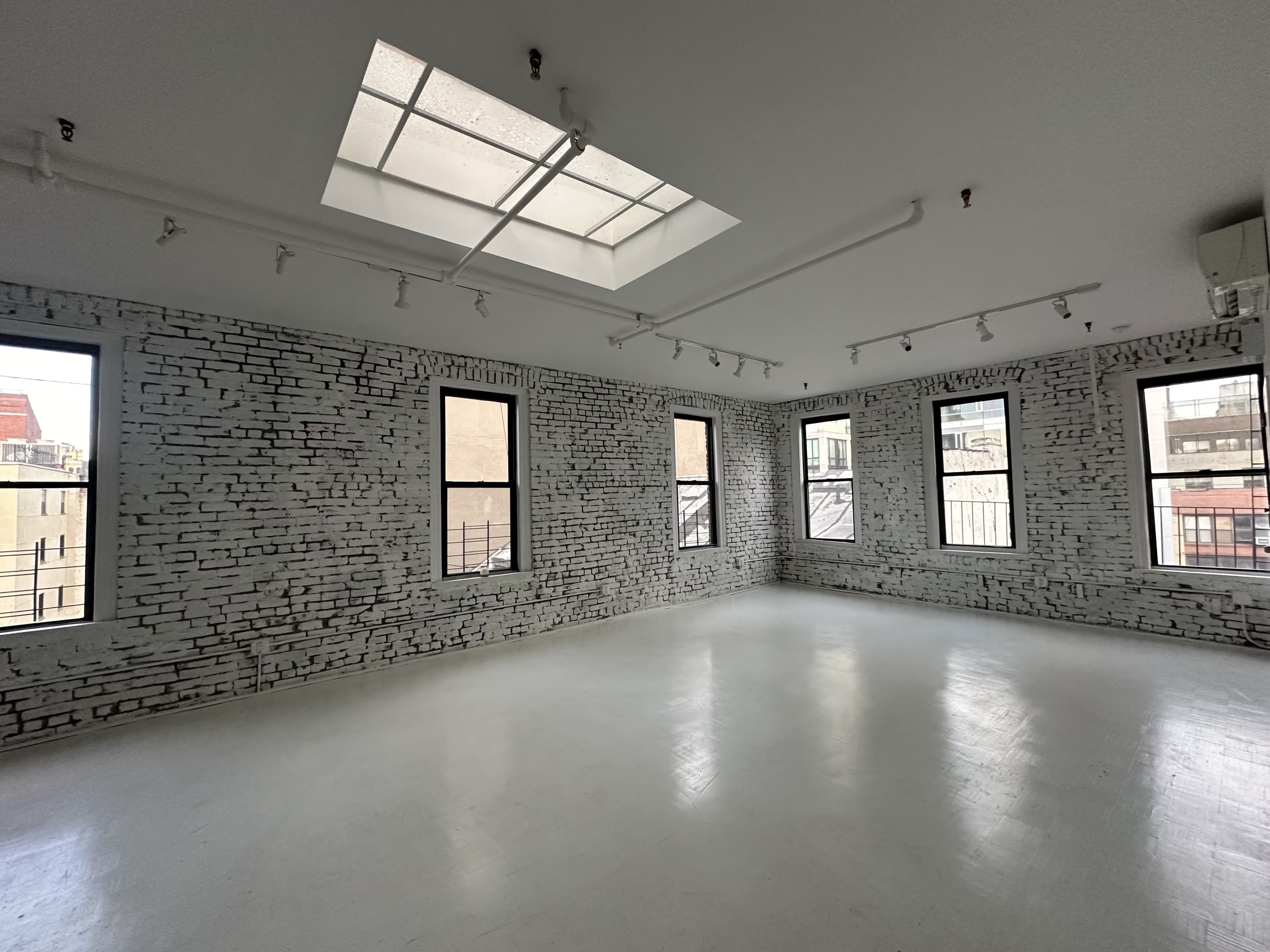 Artistic All-White Loft with Walls of Windows, Skylight & Unique Props Image in Little Italy, New York, NY