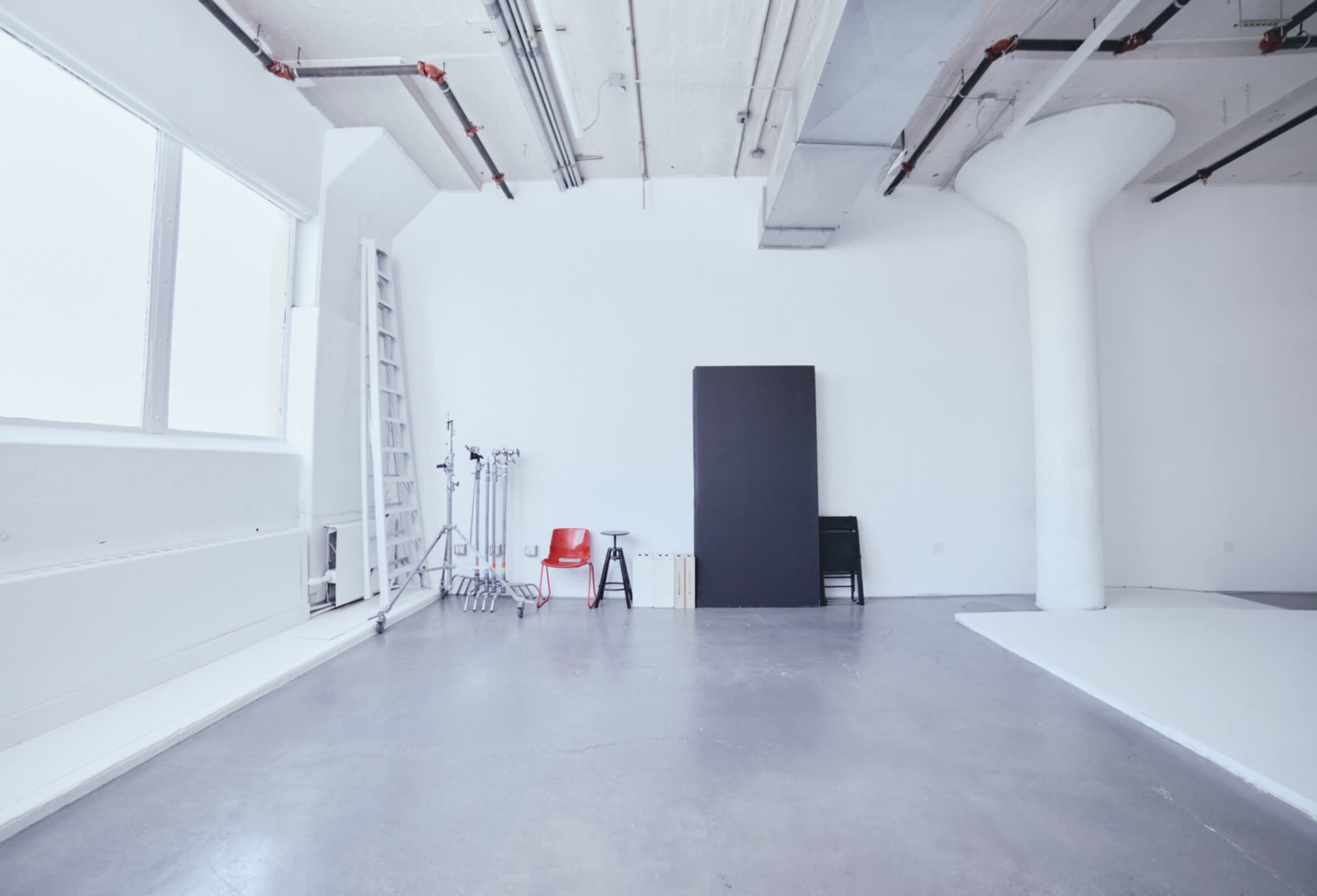 All white photo/video studio with CYC wall and concrete floors. White Rabbit Studio Image in Long Island City, Long Island City, NY