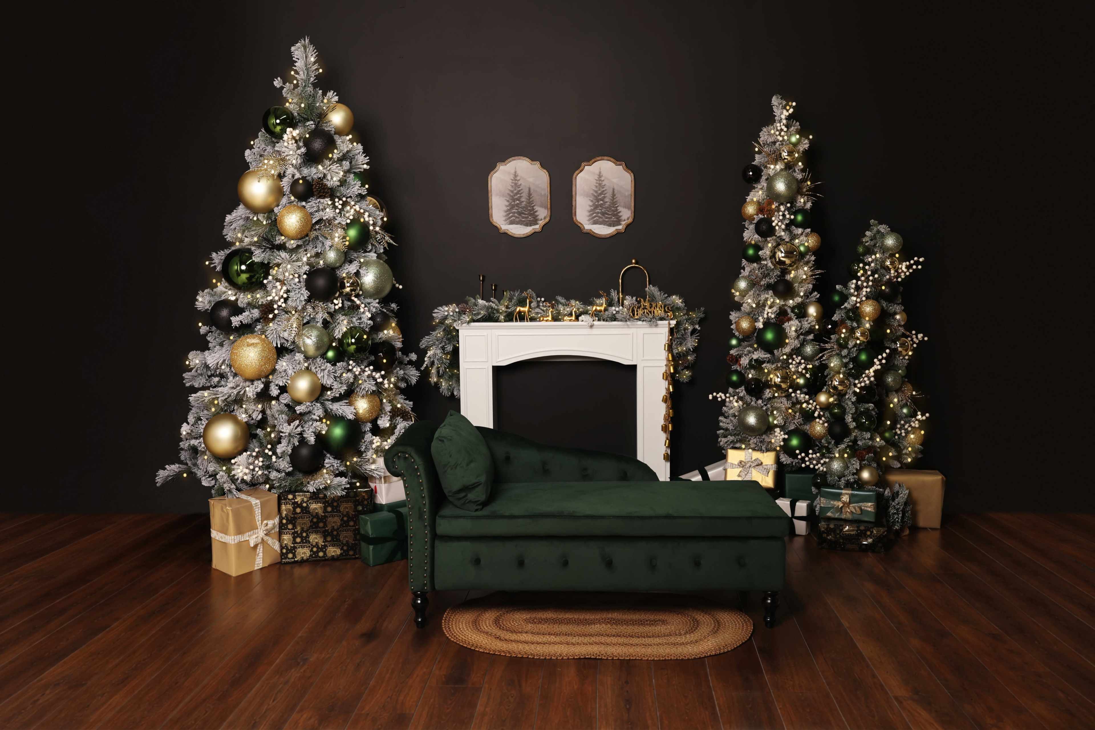 The scene features a green chaise lounge in front of a white fireplace, flanked by two decorated Christmas trees and surrounded by wrapped gifts on a wooden floor.