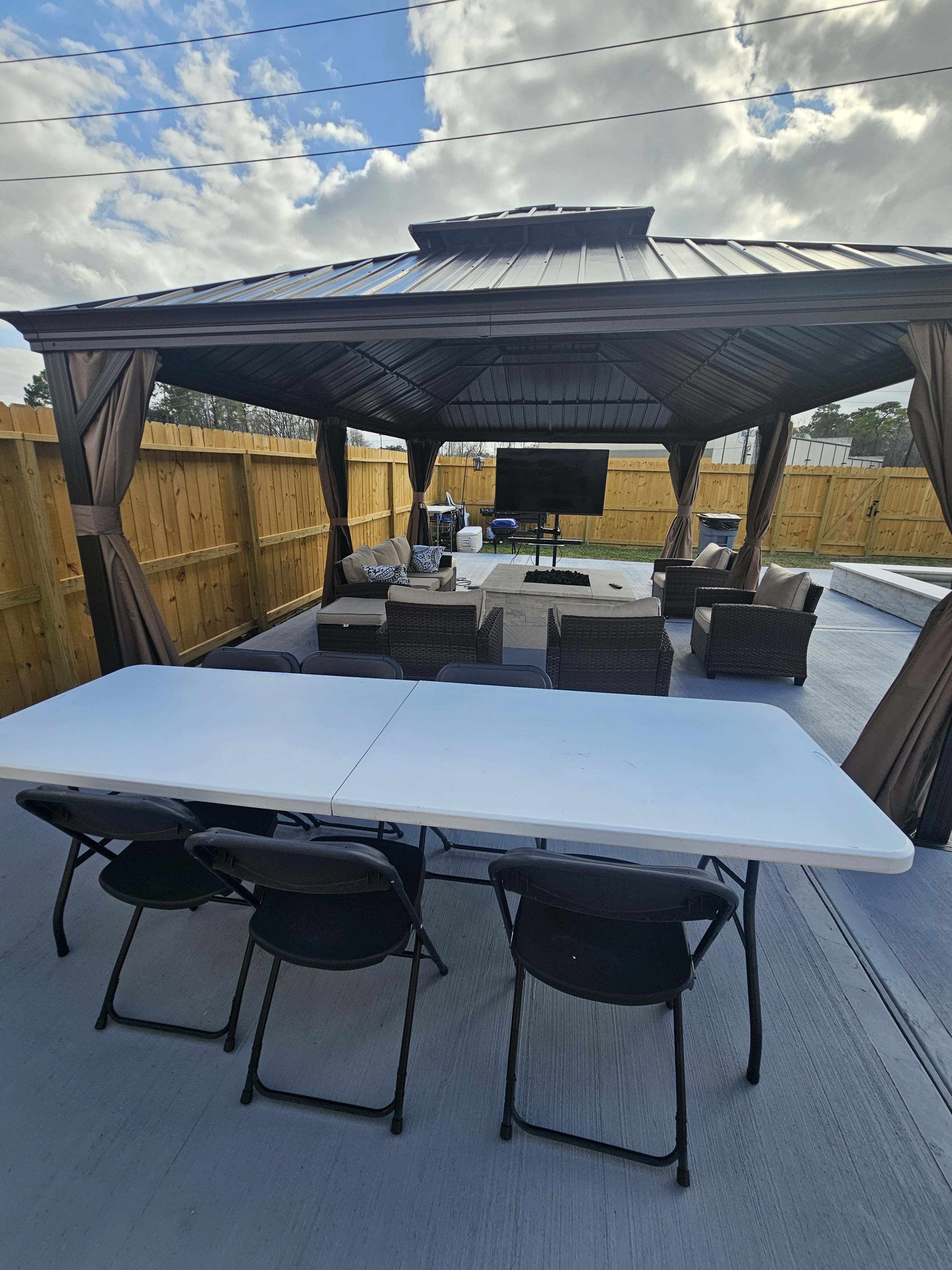 Near IAH airport spacious backyard with pool and firepit for celebrations and parties to memorable movie nights with family! Image in Humble, Humble, TX