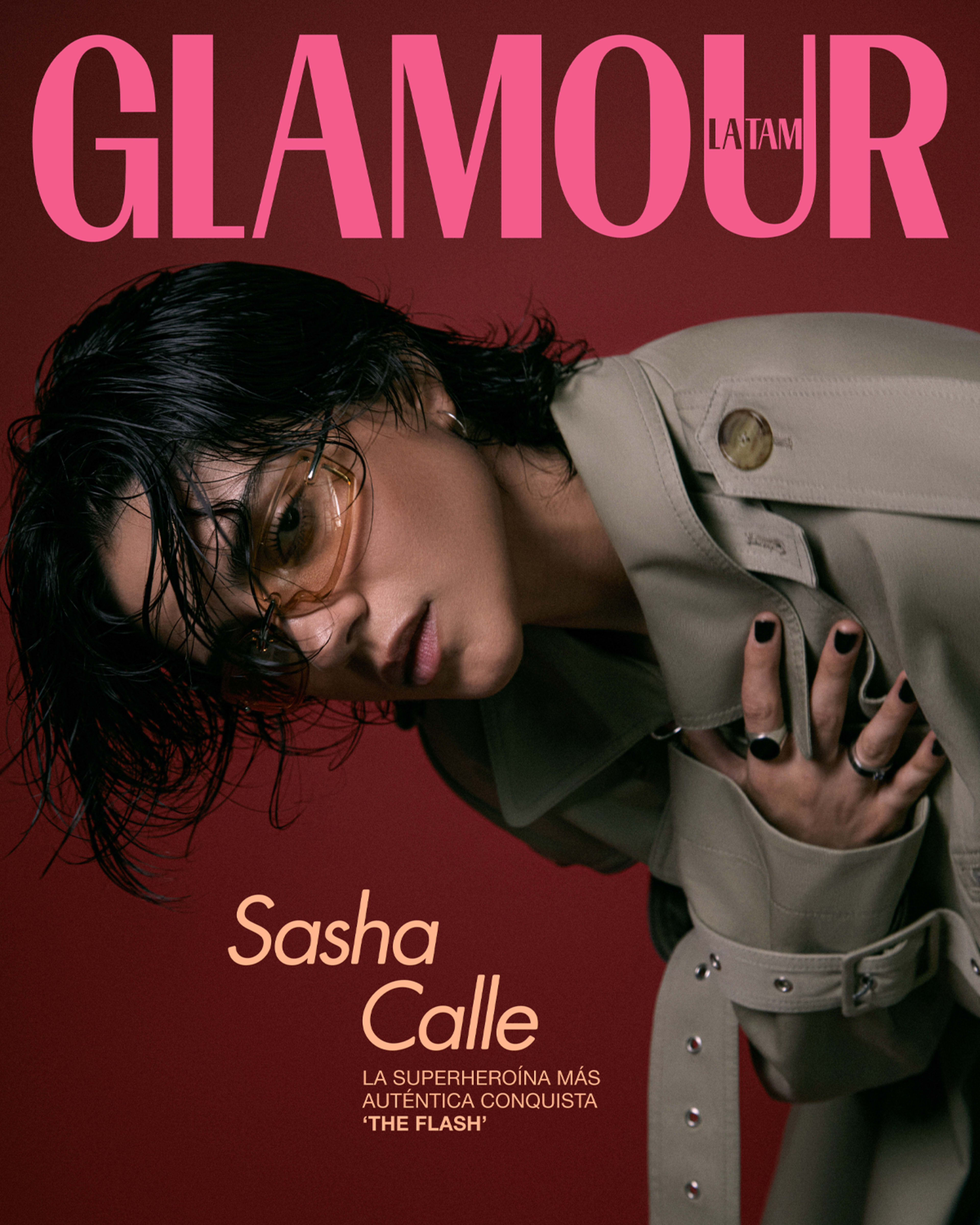 A magazine cover features a woman in a beige trench coat and sunglasses against a red background, with the headline promoting her role in "The Flash."