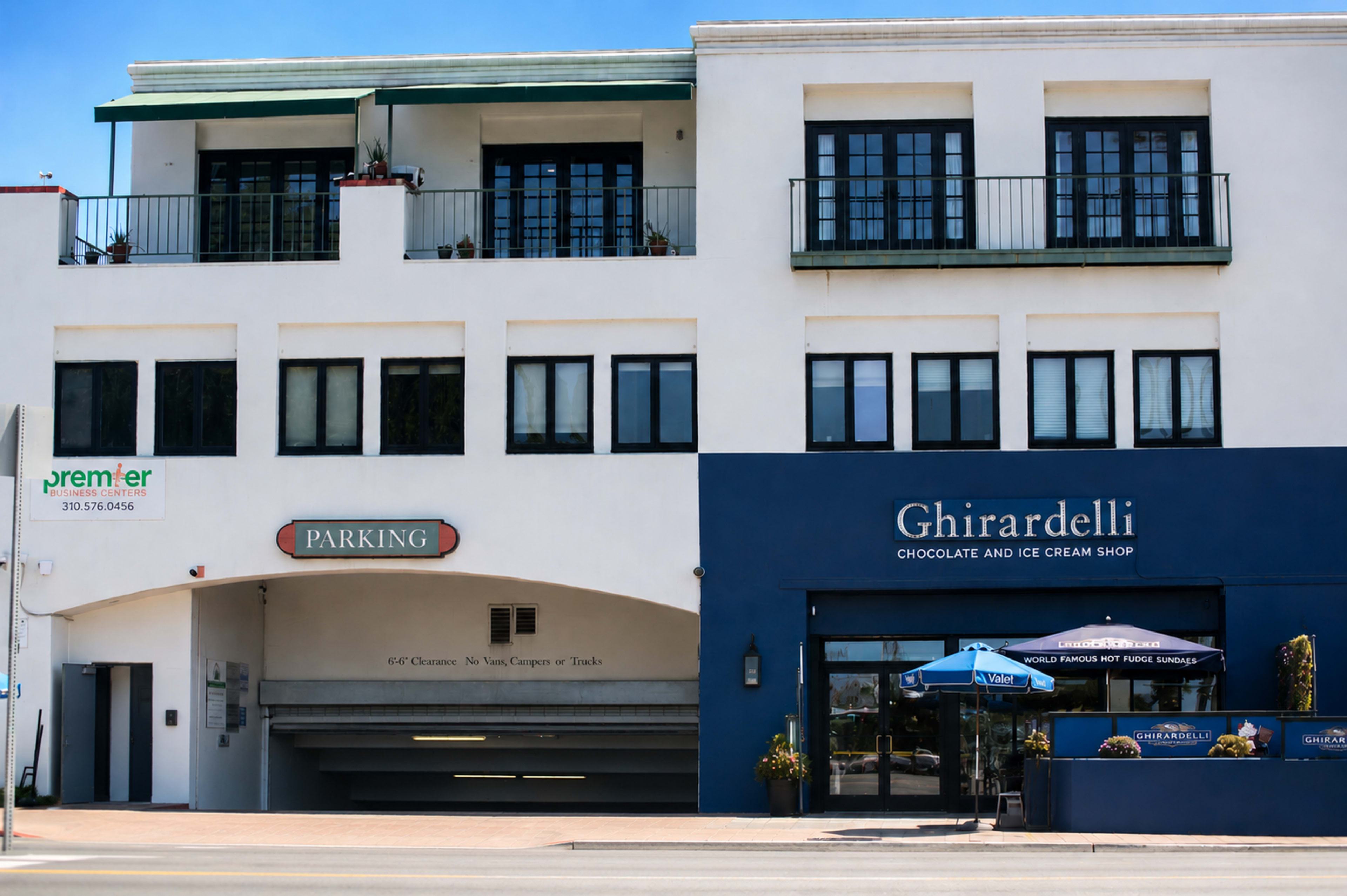 The image shows a building with a parking entrance and a Ghirardelli chocolate and ice cream shop next to it.