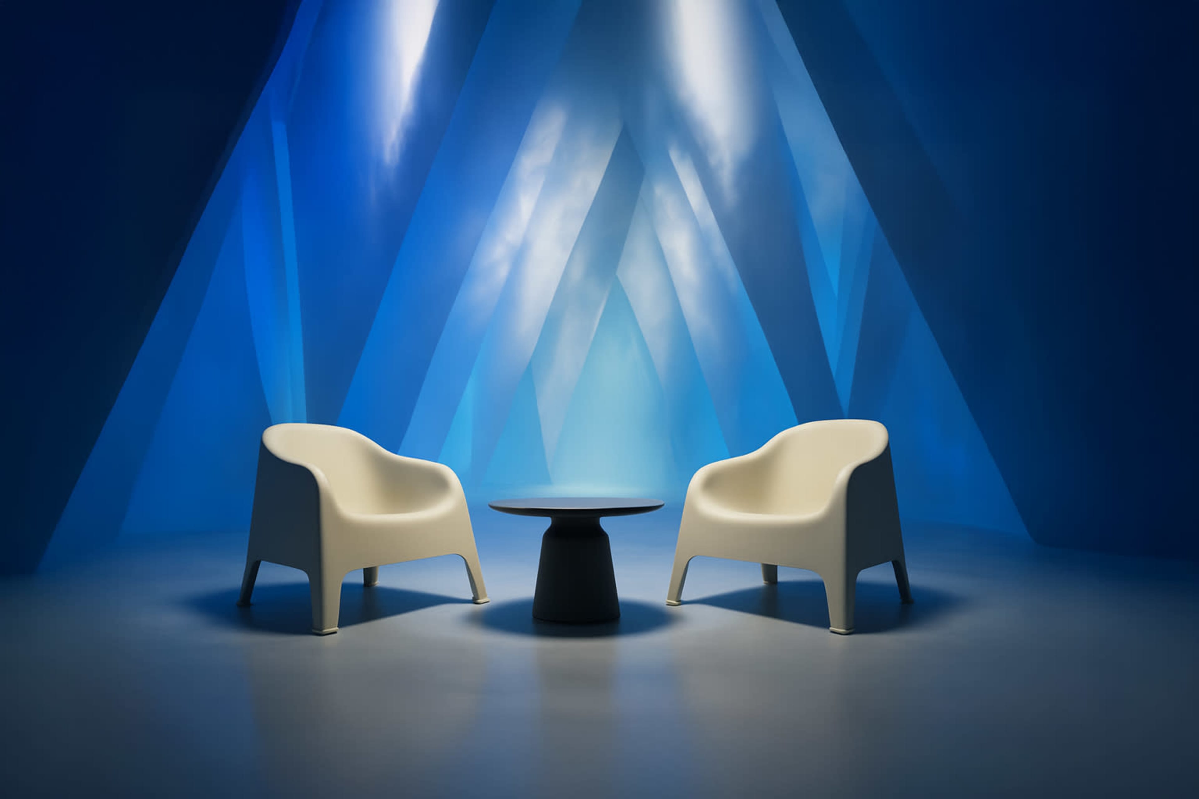 Two white chairs are placed on a smooth surface facing a small black table, set against a blue geometric background with beams of light.