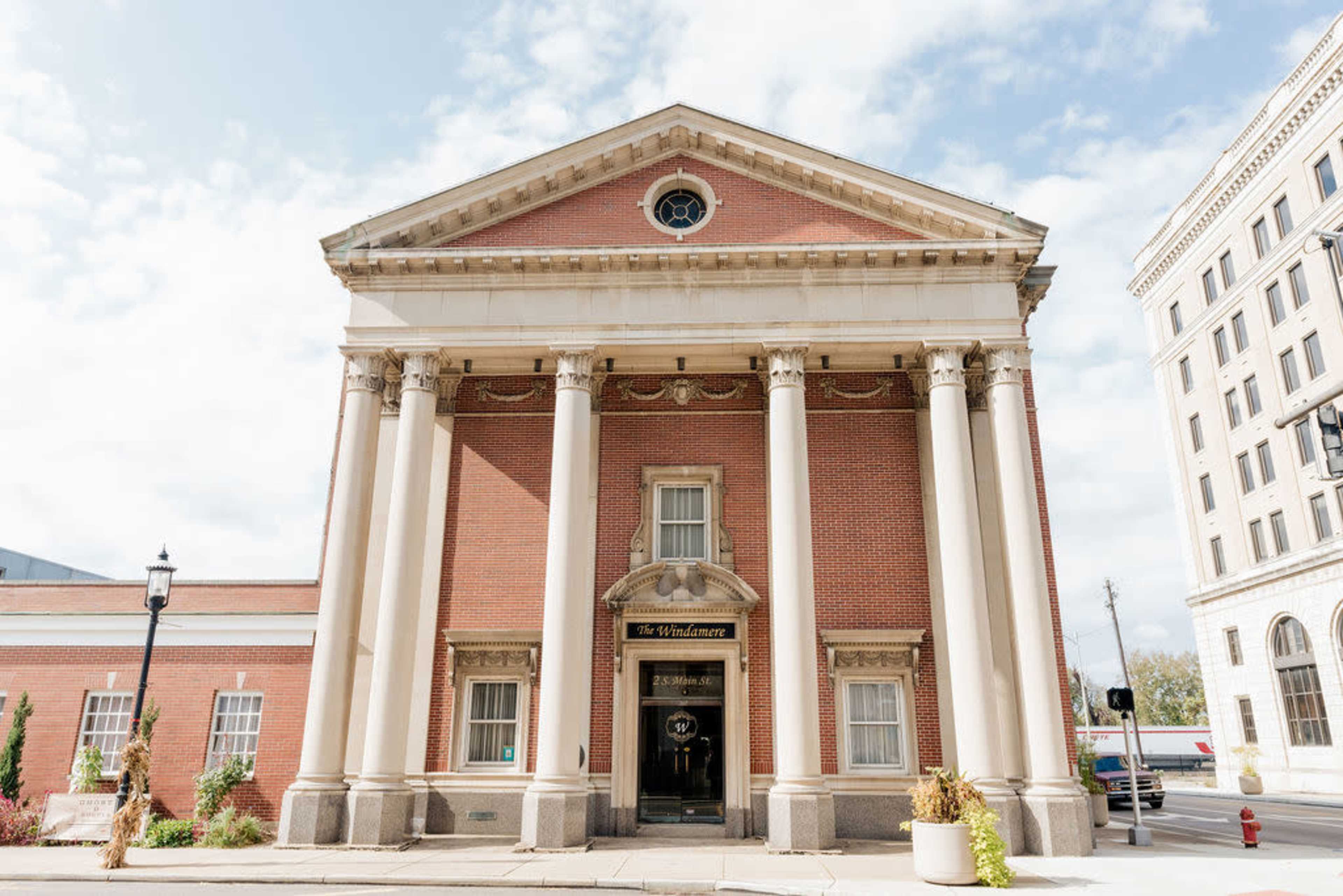 A historic building with a classical facade featuring tall columns and a triangular pediment.