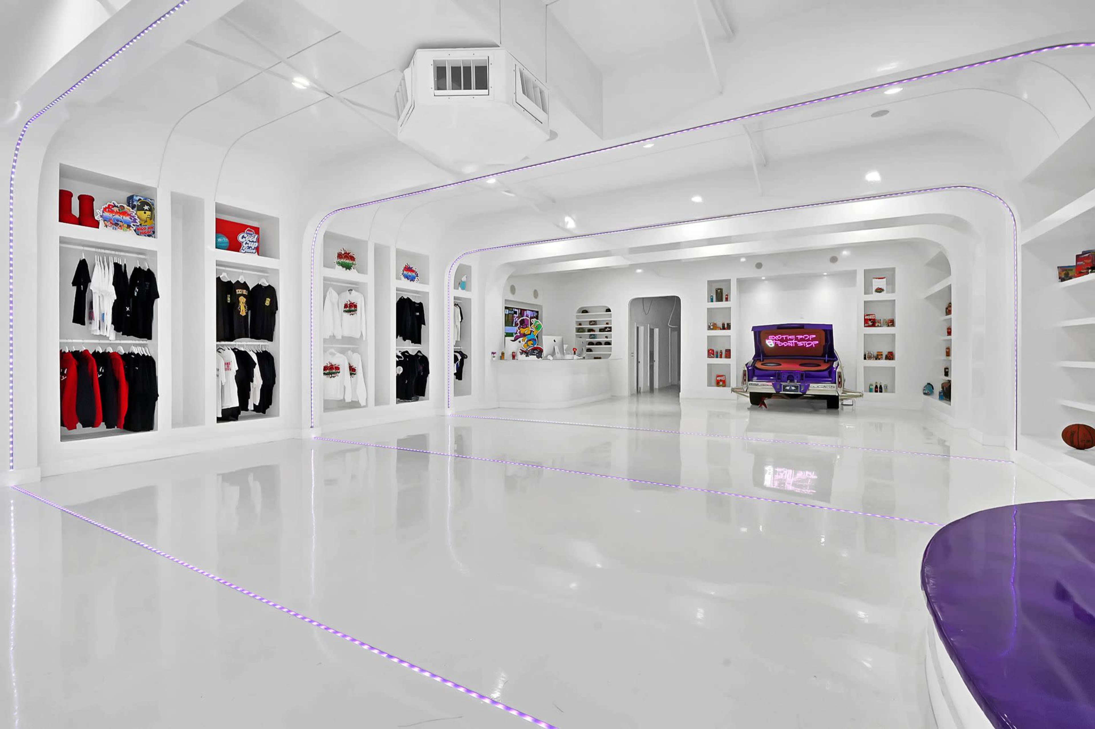 A modern, brightly lit room with a glossy white floor, featuring organized shelves with clothing and collectibles, and a central area containing a purple car.