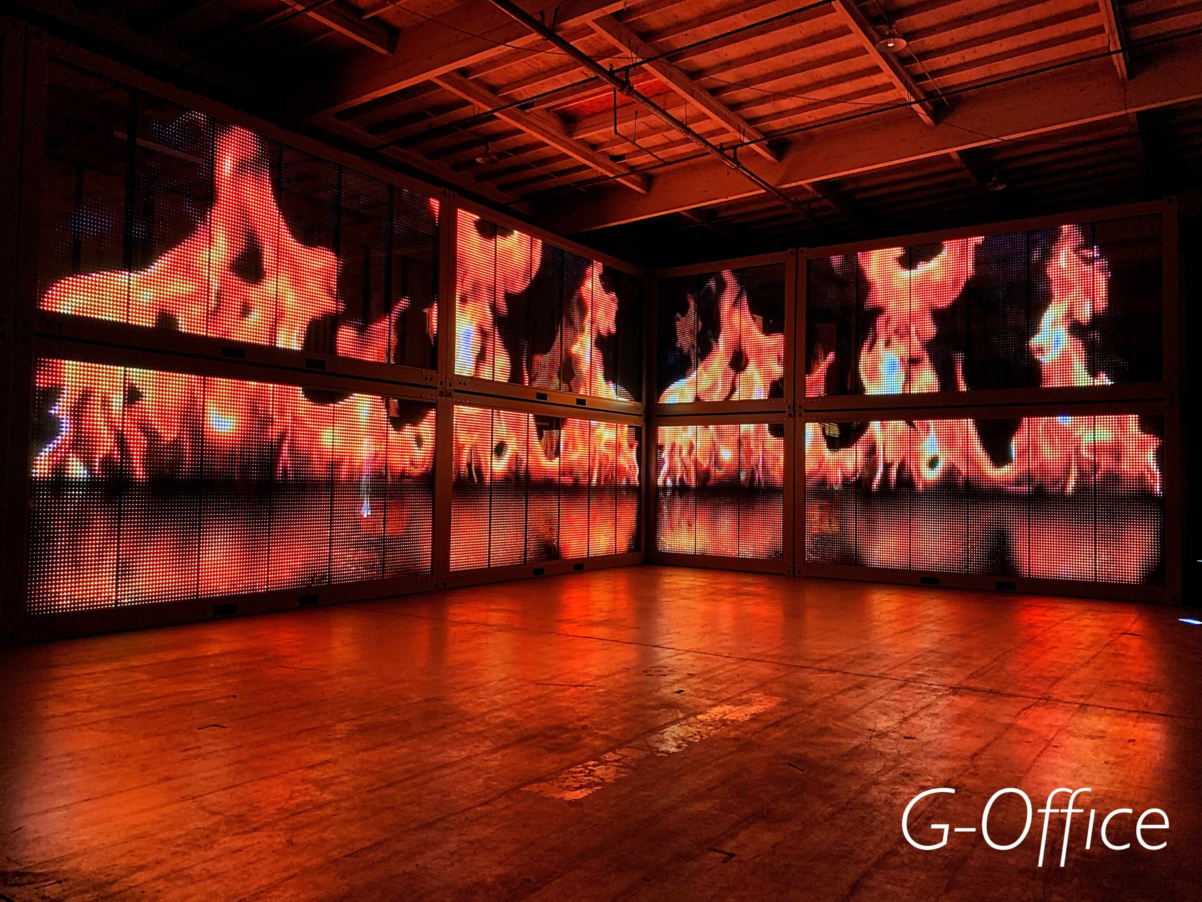A large room with walls displaying bright, animated fire graphics.