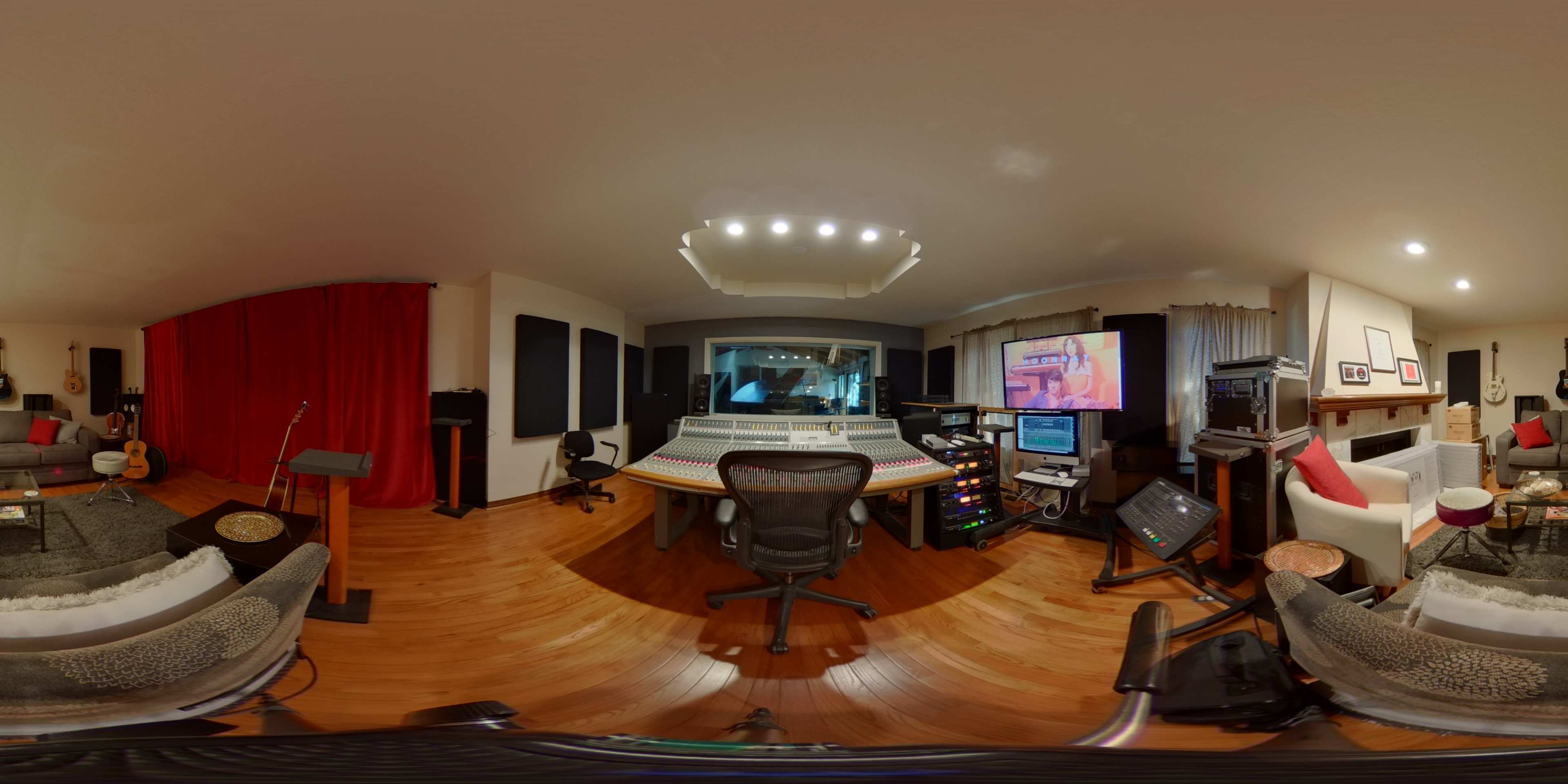 A circular view of a music studio filled with recording equipment, instruments, and soundproofing materials.