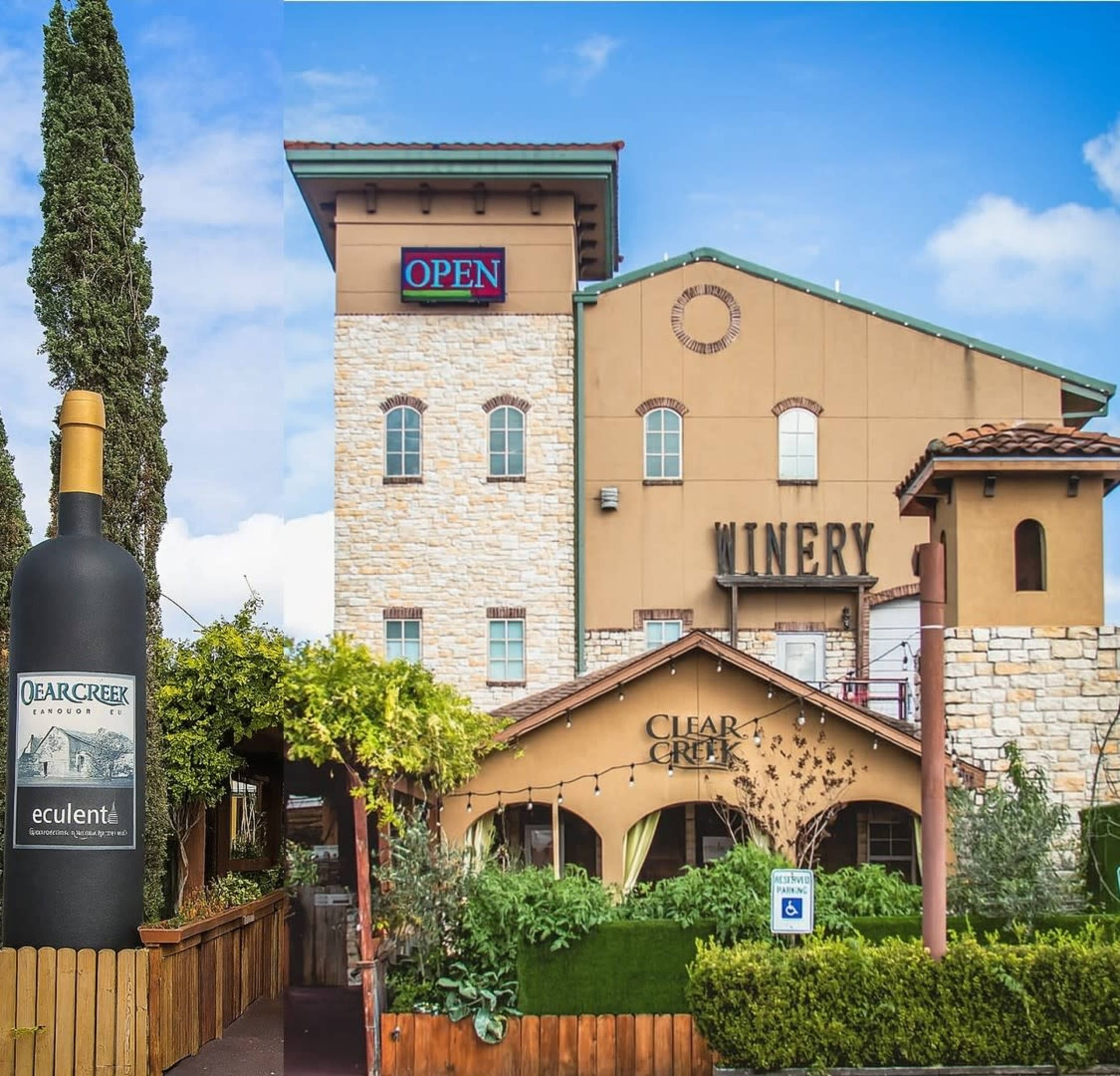 The image shows the exterior of a winery building with a large wine bottle sign in front and a “OPEN” sign on the upper section.