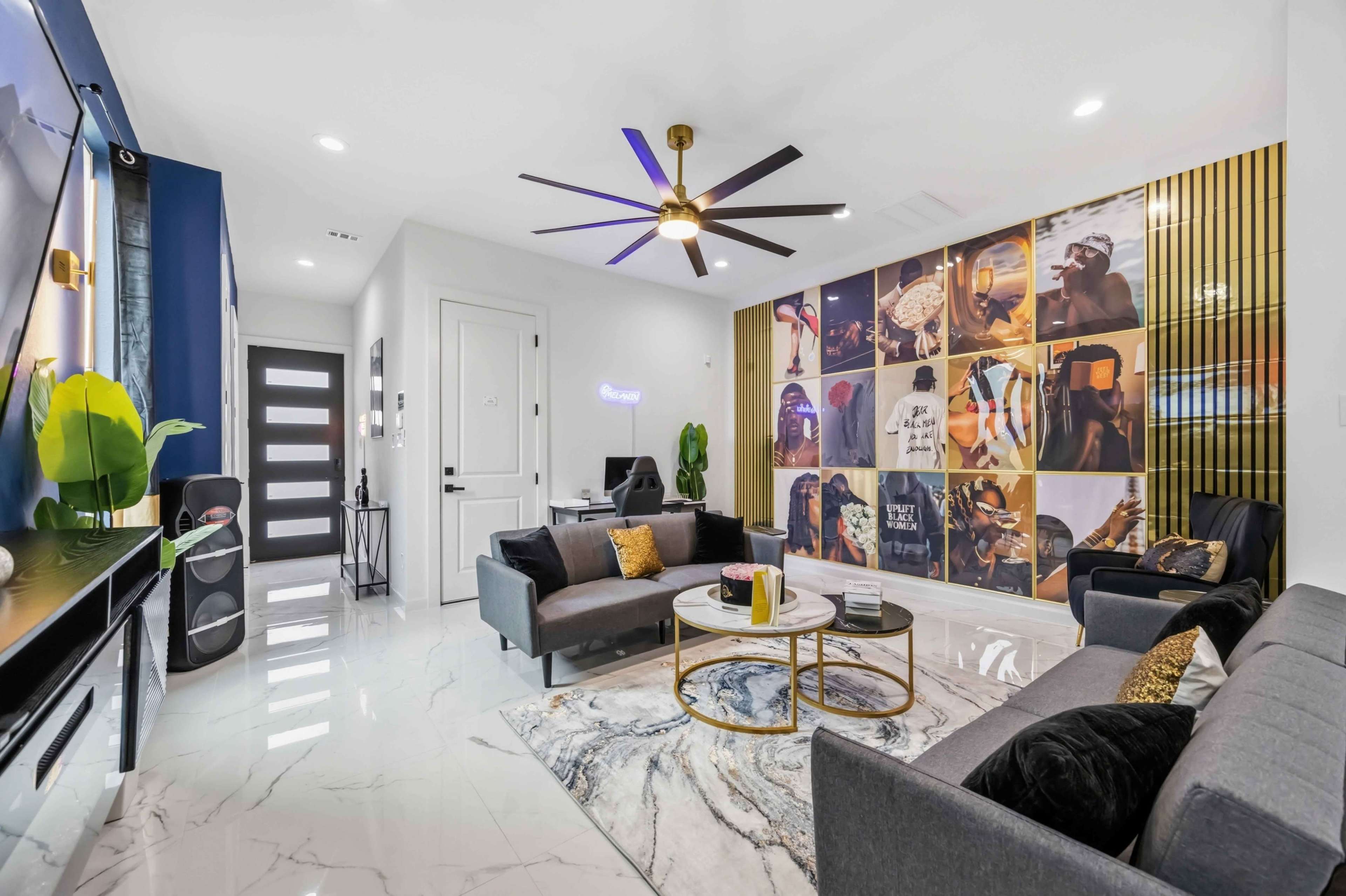 The living room features modern furniture, a large wall art display, and a glossy marble floor.