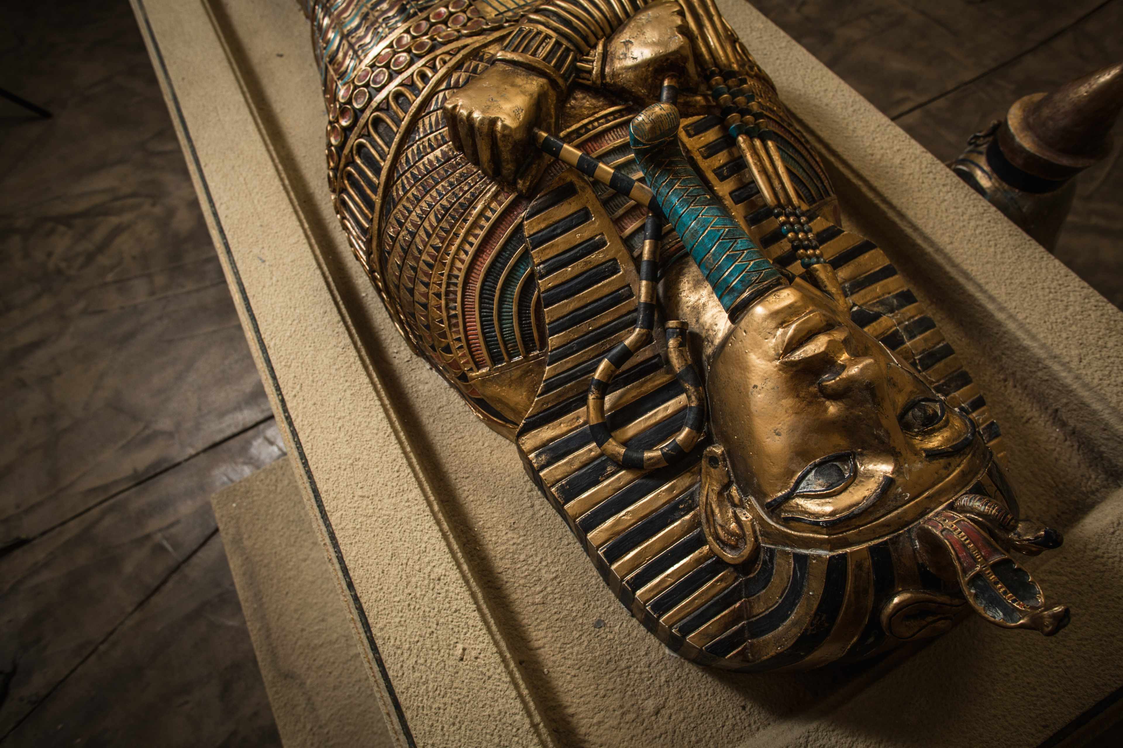 A close-up view of an ornate Egyptian sarcophagus decorated with intricate patterns and vibrant colors.
