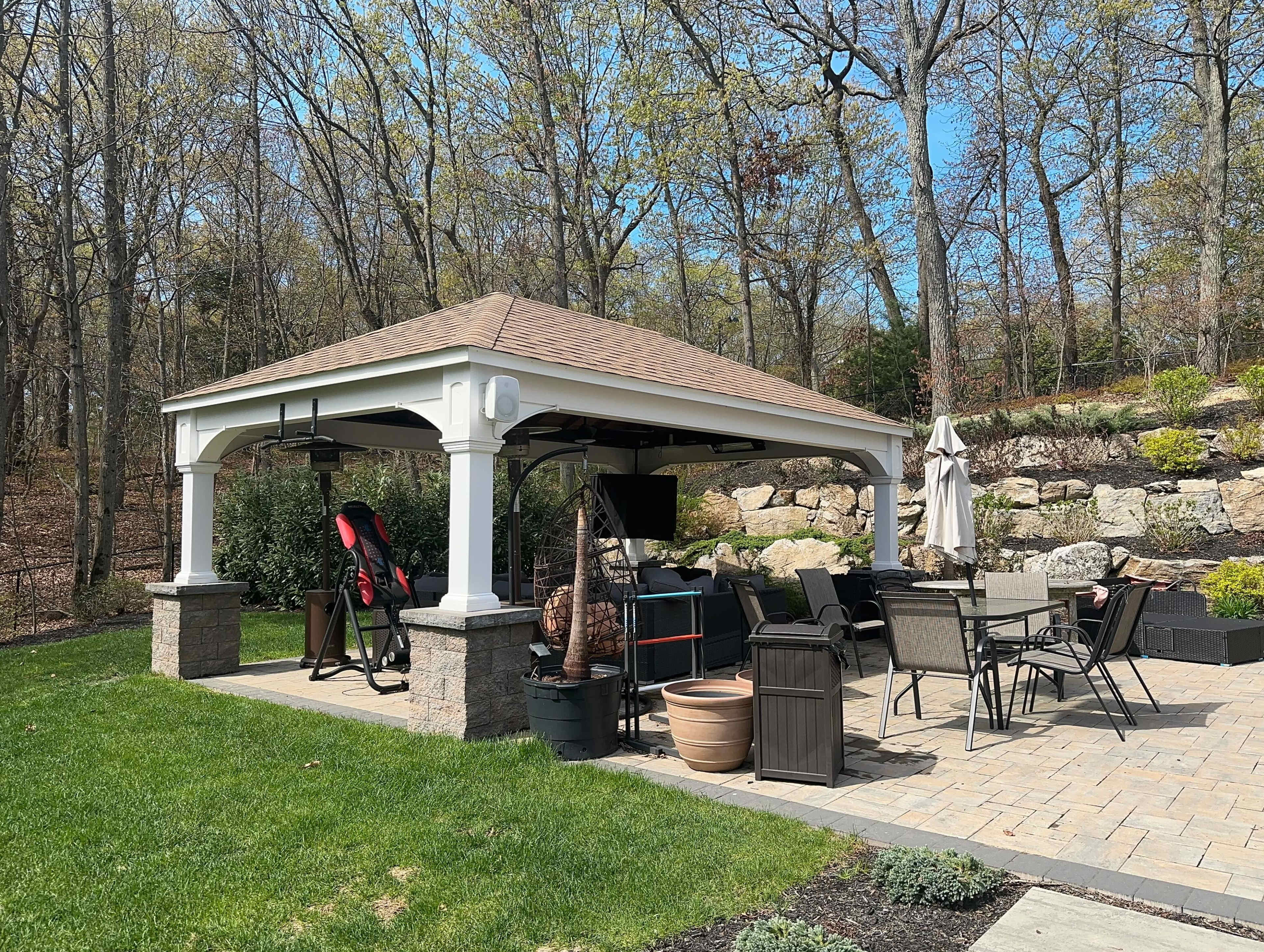 Resort style backyard with pool, pavilion, surround sound speakers and grills Image in Huntington, Melville, NY