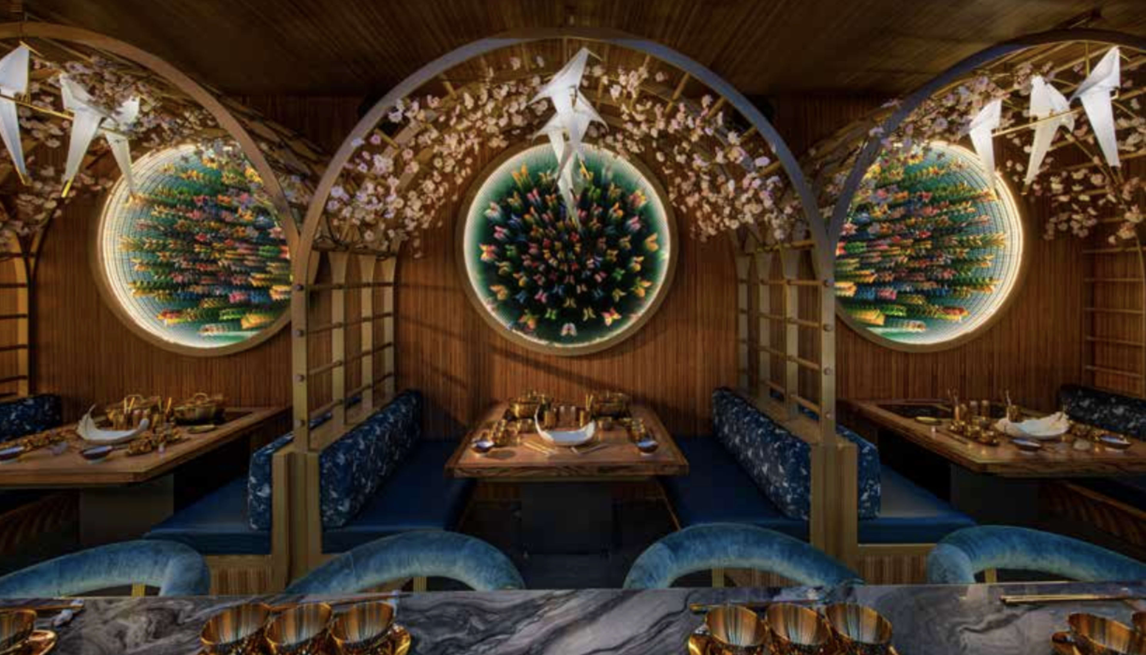 The image shows an elegantly designed restaurant interior with wooden arches, circular decorative wall art, and cozy dining areas.