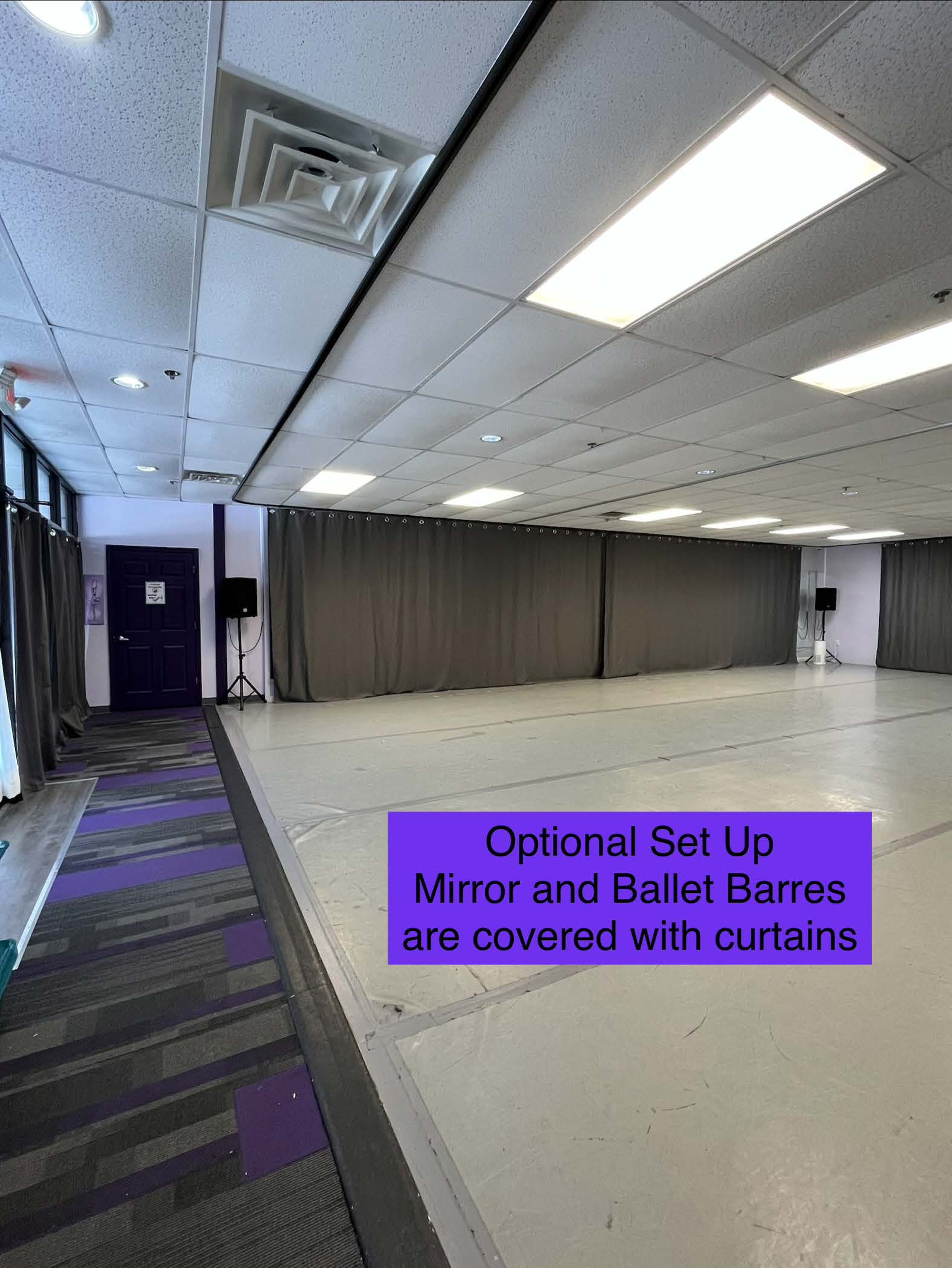 The image shows a dance studio space with gray curtains covering the mirrors and ballet bars, and a purple-accented area on the floor.