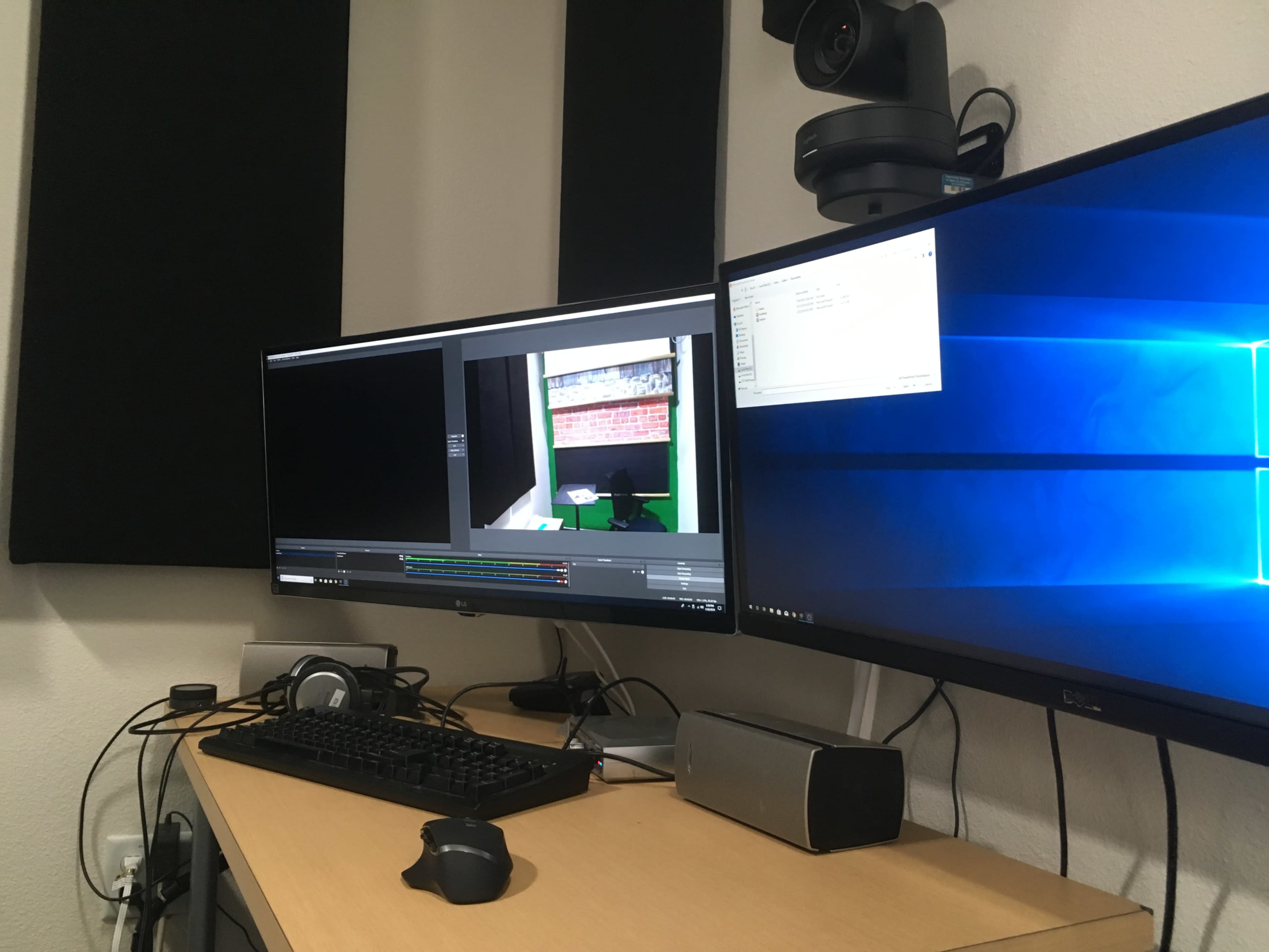 A dual-monitor setup showcases a computer screen running streaming software beside a second monitor displaying a Windows desktop.