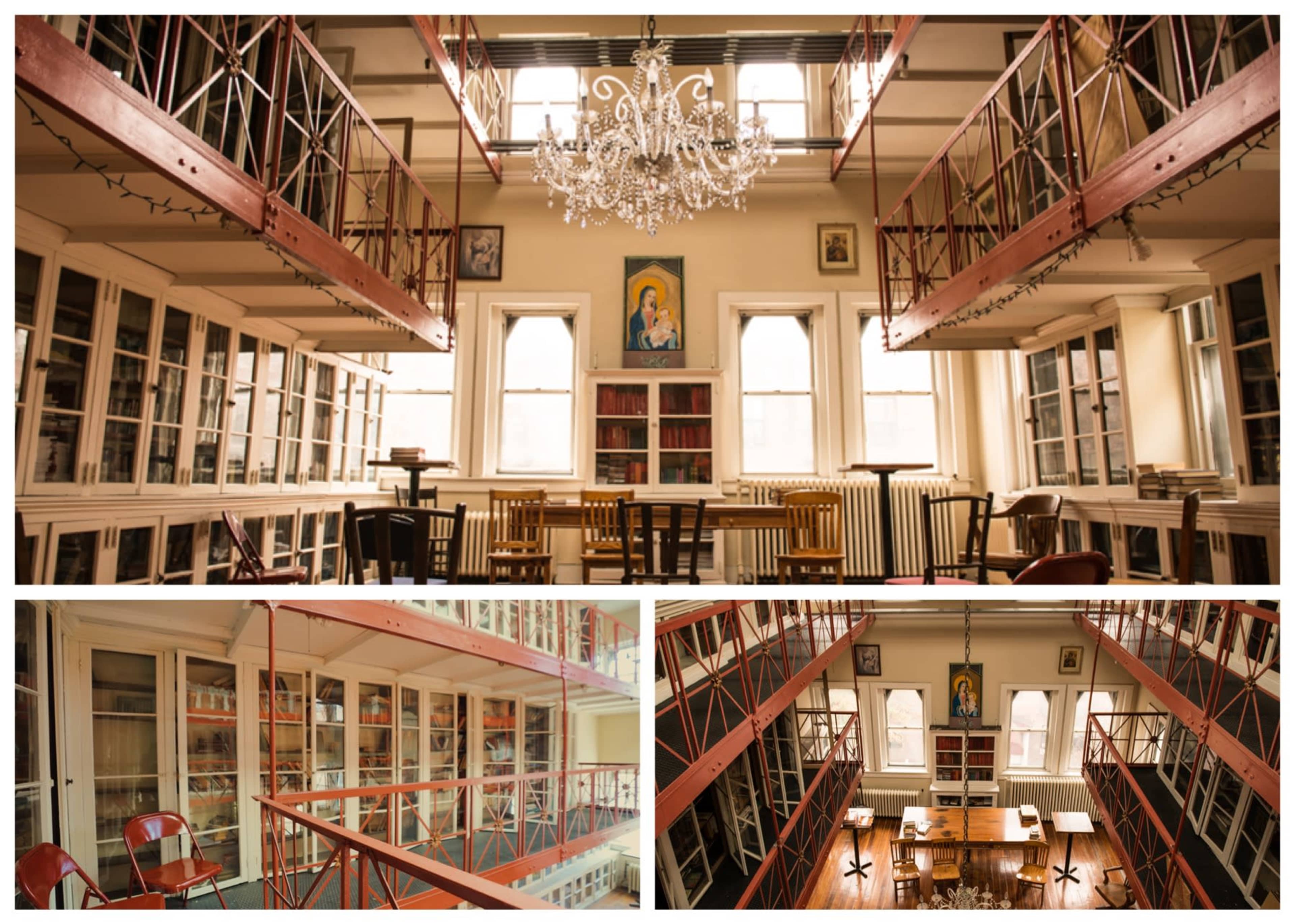 A multi-level library with a chandelier, rows of bookshelves, and tables arranged for reading and study.